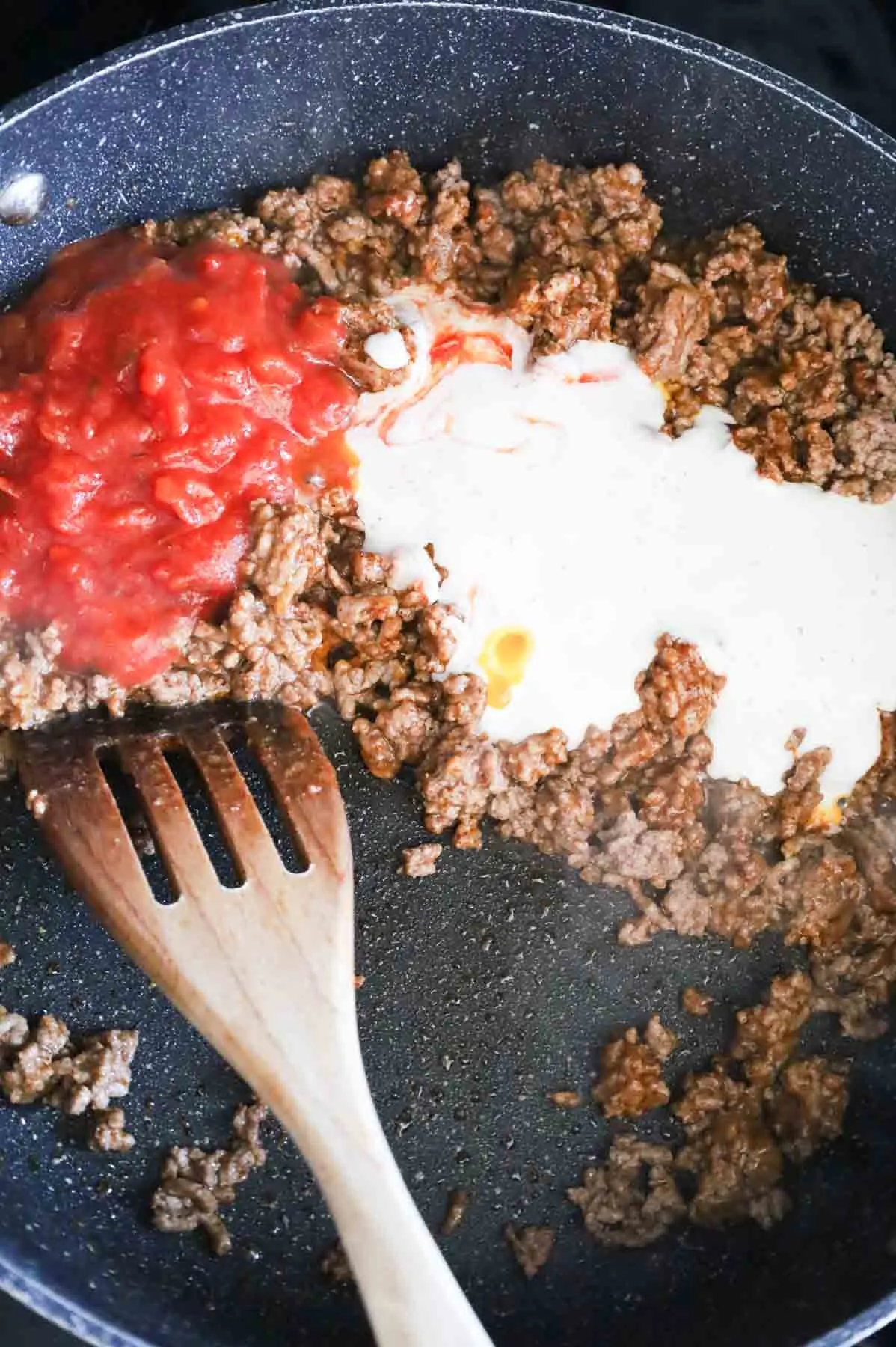 salsa and ranch dressing on top of taco seasoned ground beef in a skillet