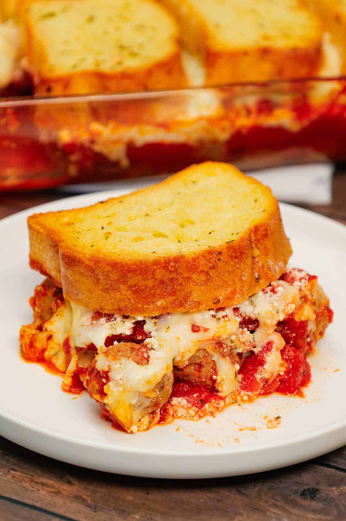 Dump and Bake Meatball Casserole is a hearty casserole made with frozen Italian meatballs, marinara sauce, diced tomatoes, ricotta and mozzarella and topped with frozen Texas toast garlic bread.