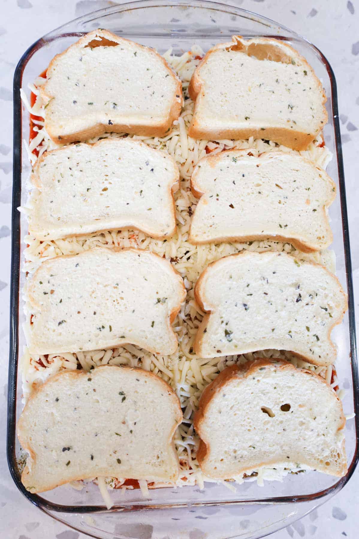 frozen garlic bread slices on top of meatball casserole