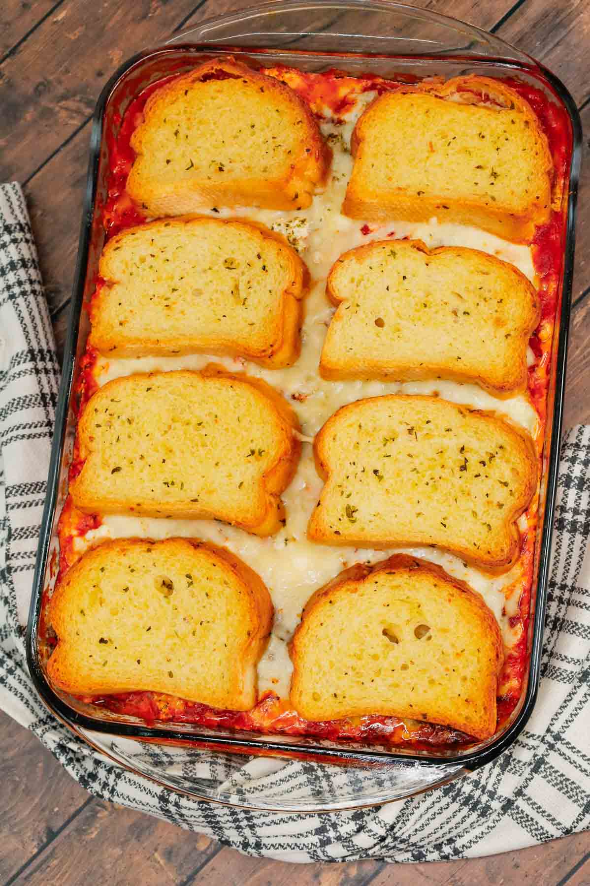 Dump and Bake Meatball Casserole is a hearty casserole made with frozen Italian meatballs, marinara sauce, diced tomatoes, ricotta and mozzarella and topped with frozen Texas toast garlic bread.