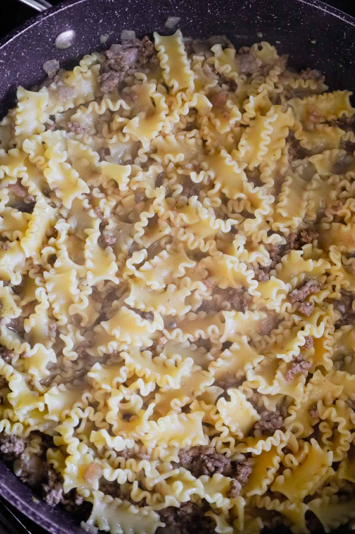 cooked pasta and ground beef in a skillet