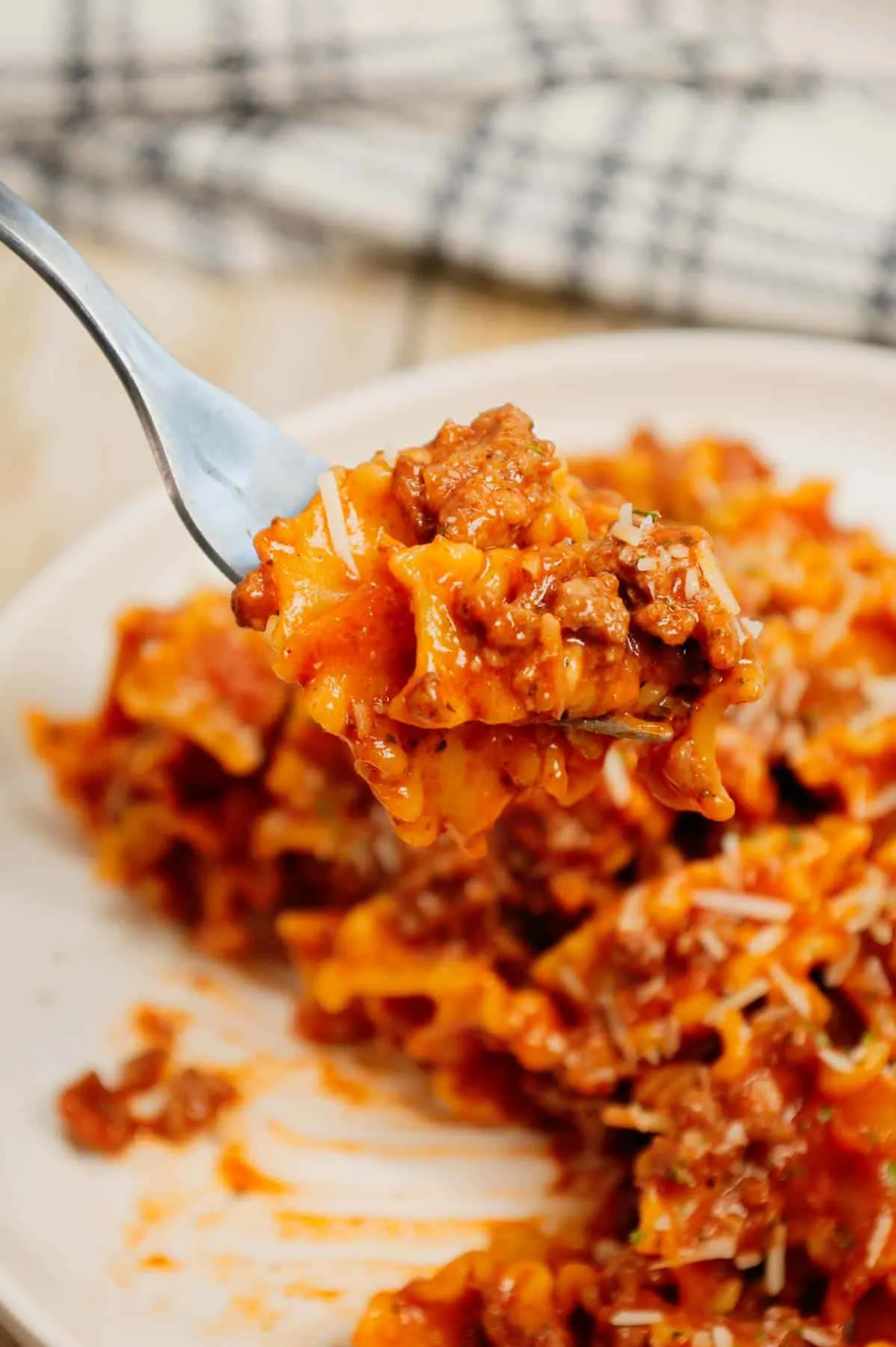 Hamburger Helper Lasagna is an easy ground beef dinner recipe using pasta that looks like mini lasagna noodles, tomato sauce, Italian seasoning, beef broth, shredded mozzarella and parmesan cheese.