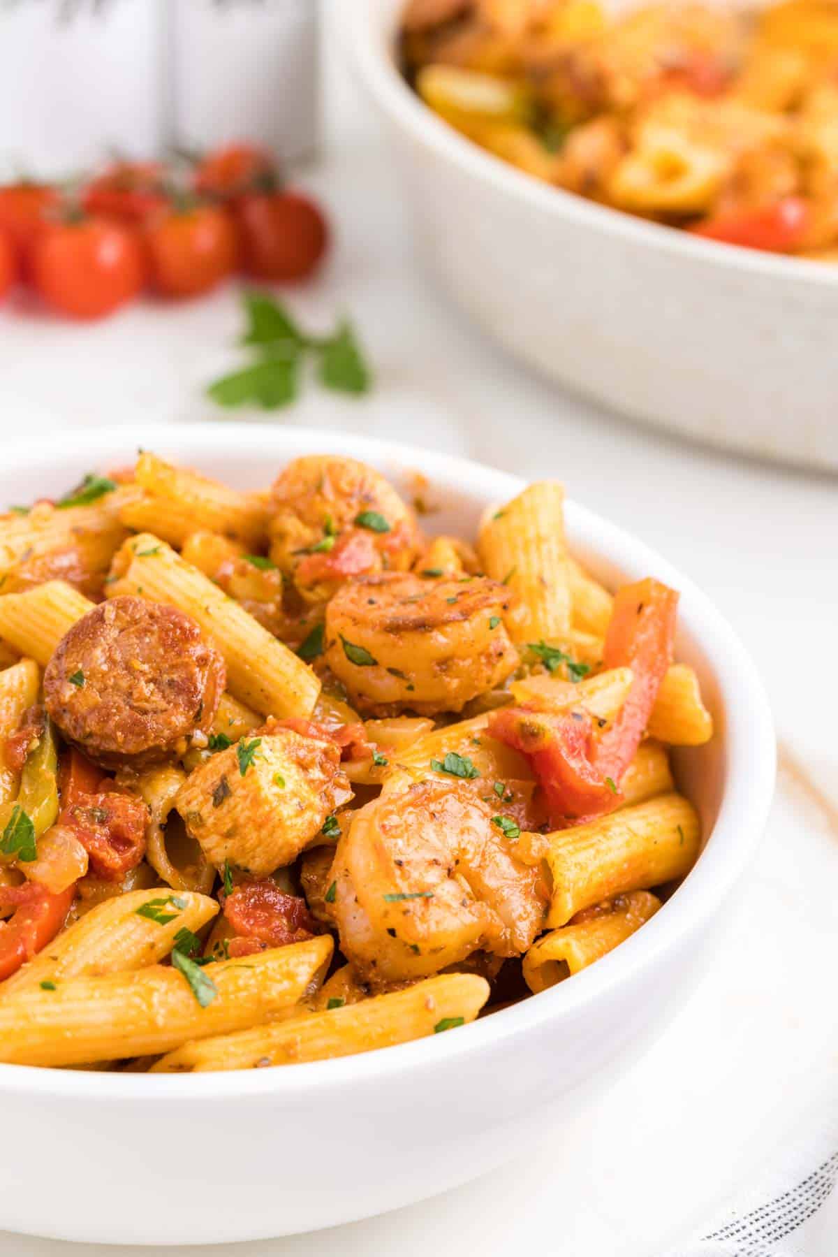 Jambalaya Pasta is a hearty penne pasta recipe loaded with bell peppers, shrimp, chicken breast chunks and andouille sausage all tossed in a tomato based sauce with a kick from some Cajun seasoning.