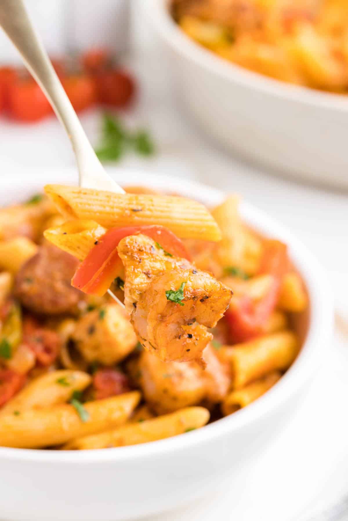 Jambalaya Pasta is a hearty penne pasta recipe loaded with bell peppers, shrimp, chicken breast chunks and andouille sausage all tossed in a tomato based sauce with a kick from some Cajun seasoning.