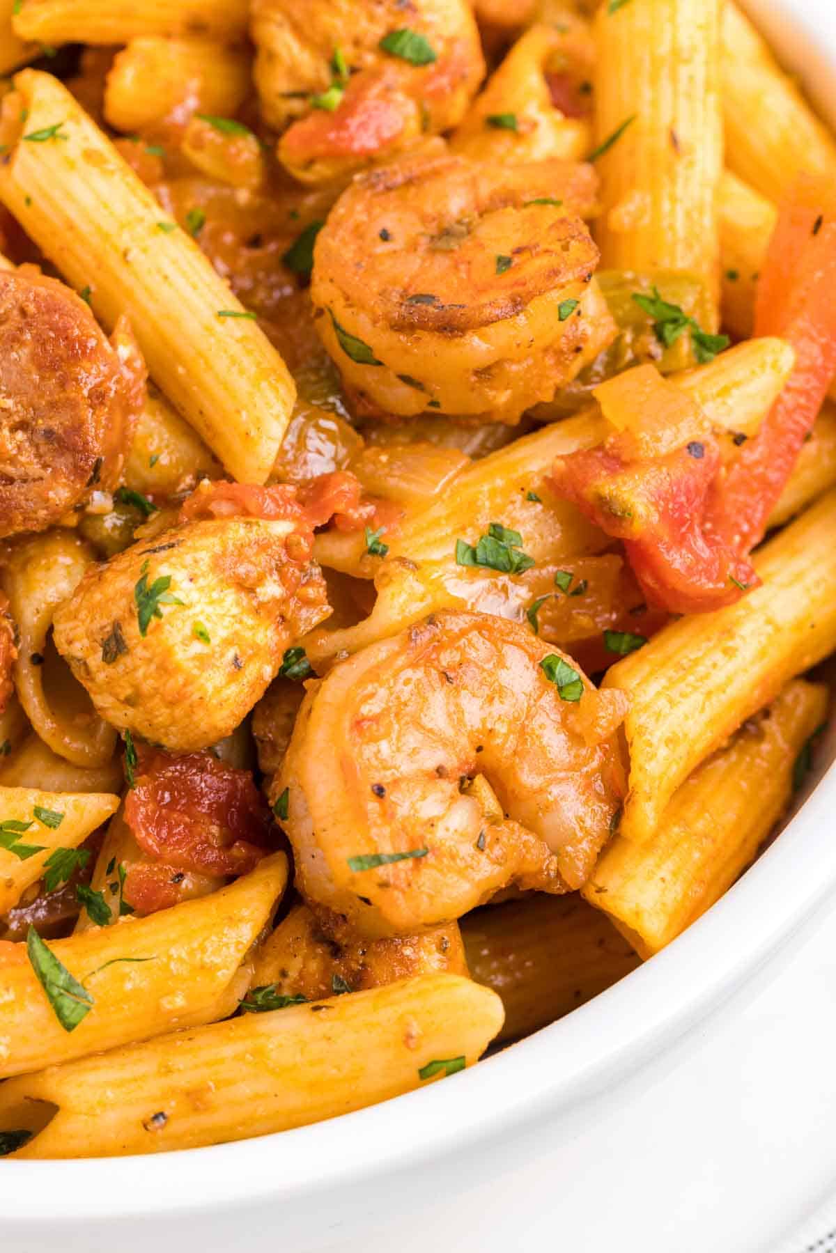 Jambalaya Pasta is a hearty penne pasta recipe loaded with bell peppers, shrimp, chicken breast chunks and andouille sausage all tossed in a tomato based sauce with a kick from some Cajun seasoning.