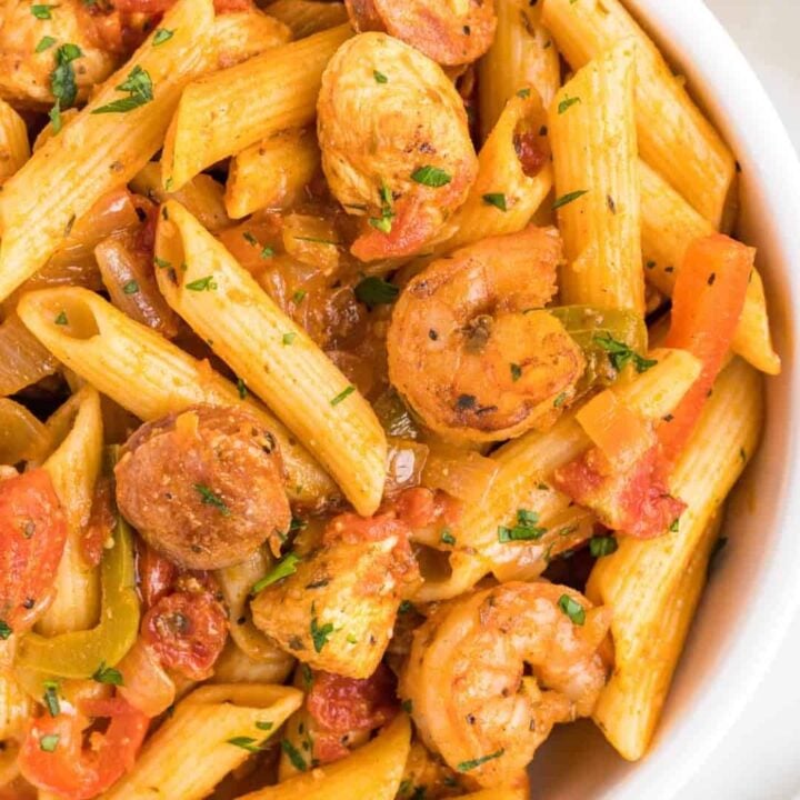 Jambalaya Pasta is a hearty penne pasta recipe loaded with bell peppers, shrimp, chicken breast chunks and andouille sausage all tossed in a tomato based sauce with a kick from some Cajun seasoning.