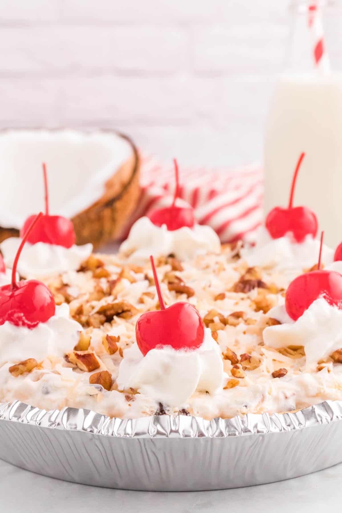 Million Dollar Pie is a creamy no bake pie loaded with crushed pineapple, chopped pecans, toasted coconut, maraschino cherries, mini marshmallows and chocolate chips all in a graham cracker crust.