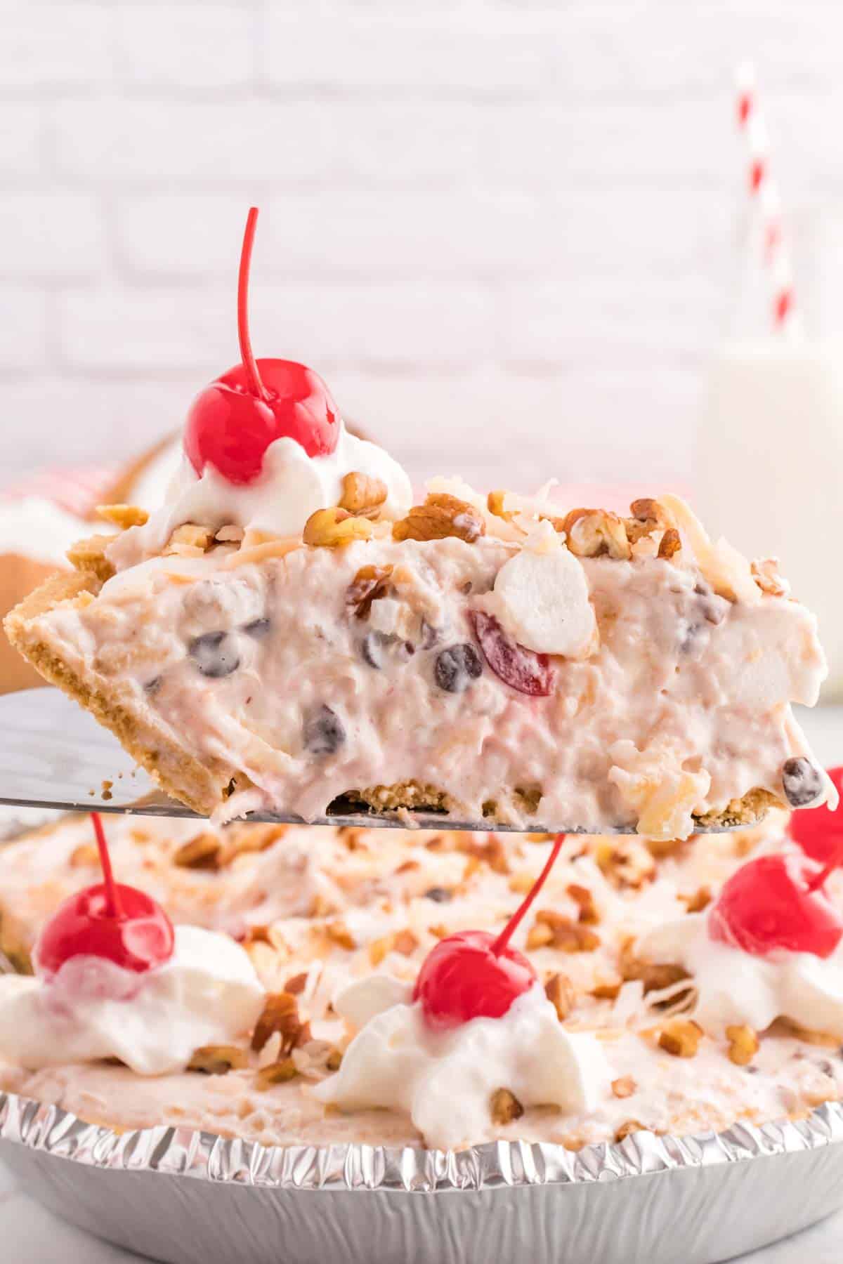 Million Dollar Pie is a creamy no bake pie loaded with crushed pineapple, chopped pecans, toasted coconut, maraschino cherries, mini marshmallows and chocolate chips all in a graham cracker crust.