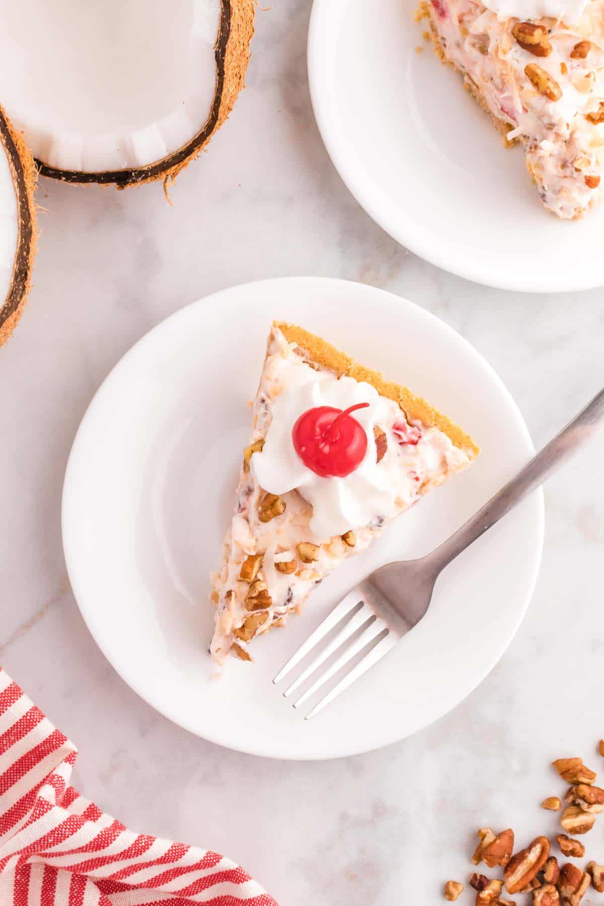 Million Dollar Pie is a creamy no bake pie loaded with crushed pineapple, chopped pecans, toasted coconut, maraschino cherries, mini marshmallows and chocolate chips all in a graham cracker crust.