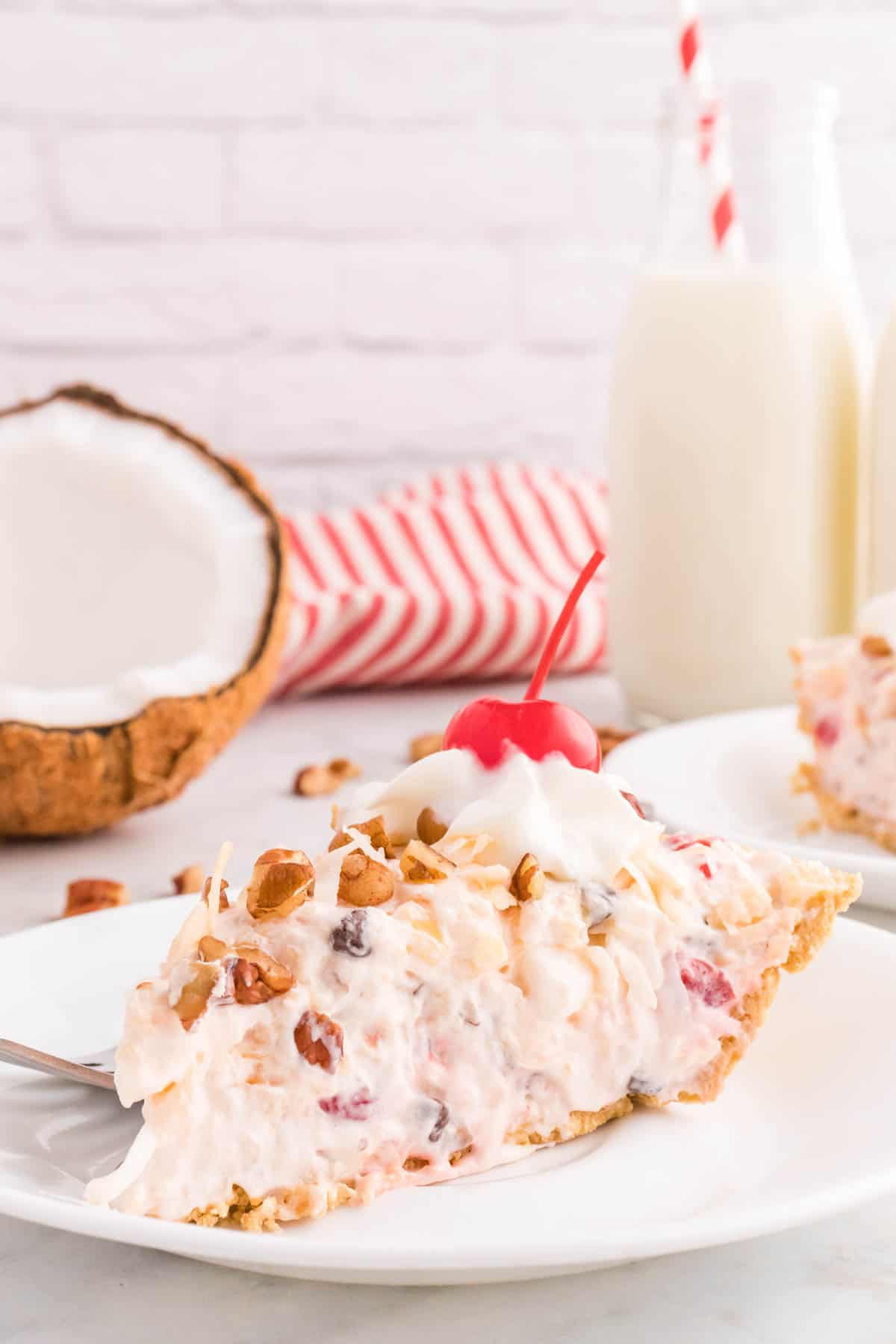 Million Dollar Pie is a creamy no bake pie loaded with crushed pineapple, chopped pecans, toasted coconut, maraschino cherries, mini marshmallows and chocolate chips all in a graham cracker crust.