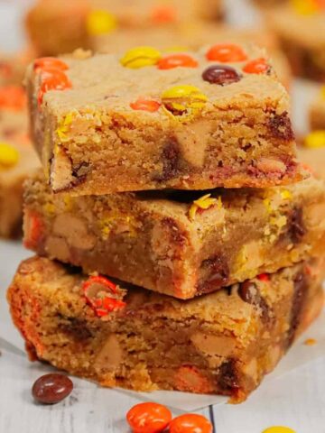 Peanut Butter Blondies are chewy peanut butter bars loaded with peanut butter baking chips, chocolate chips and mini Reese's pieces candies.