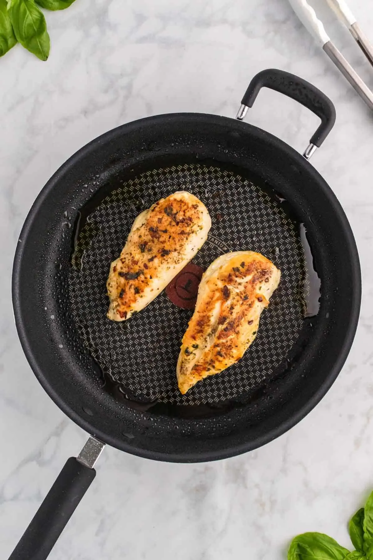cooked, seasoned chicken breasts in a skillet