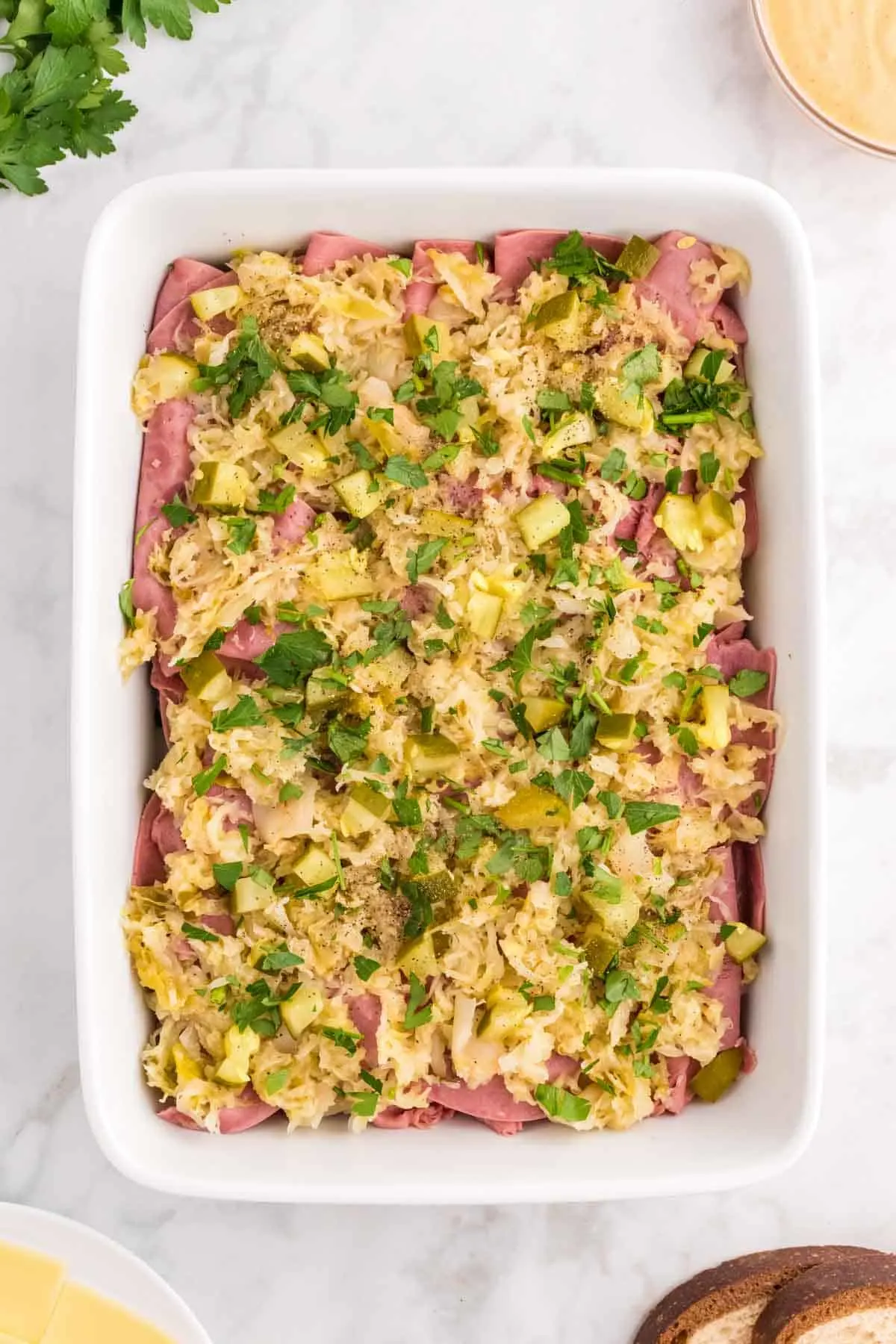 chopped parsley, chopped pickles, sauerkraut and corned beef in a casserole dish