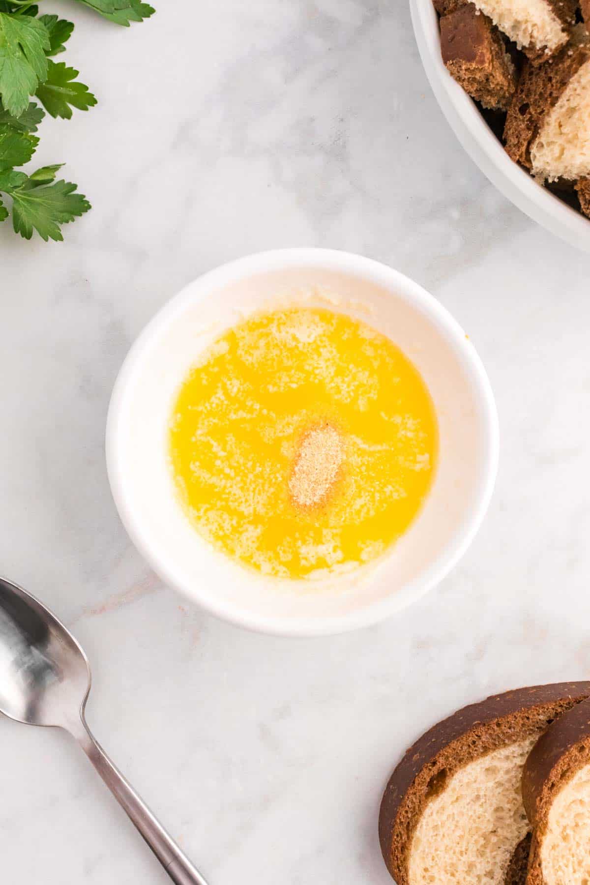 melted butter and garlic powder in a bowl