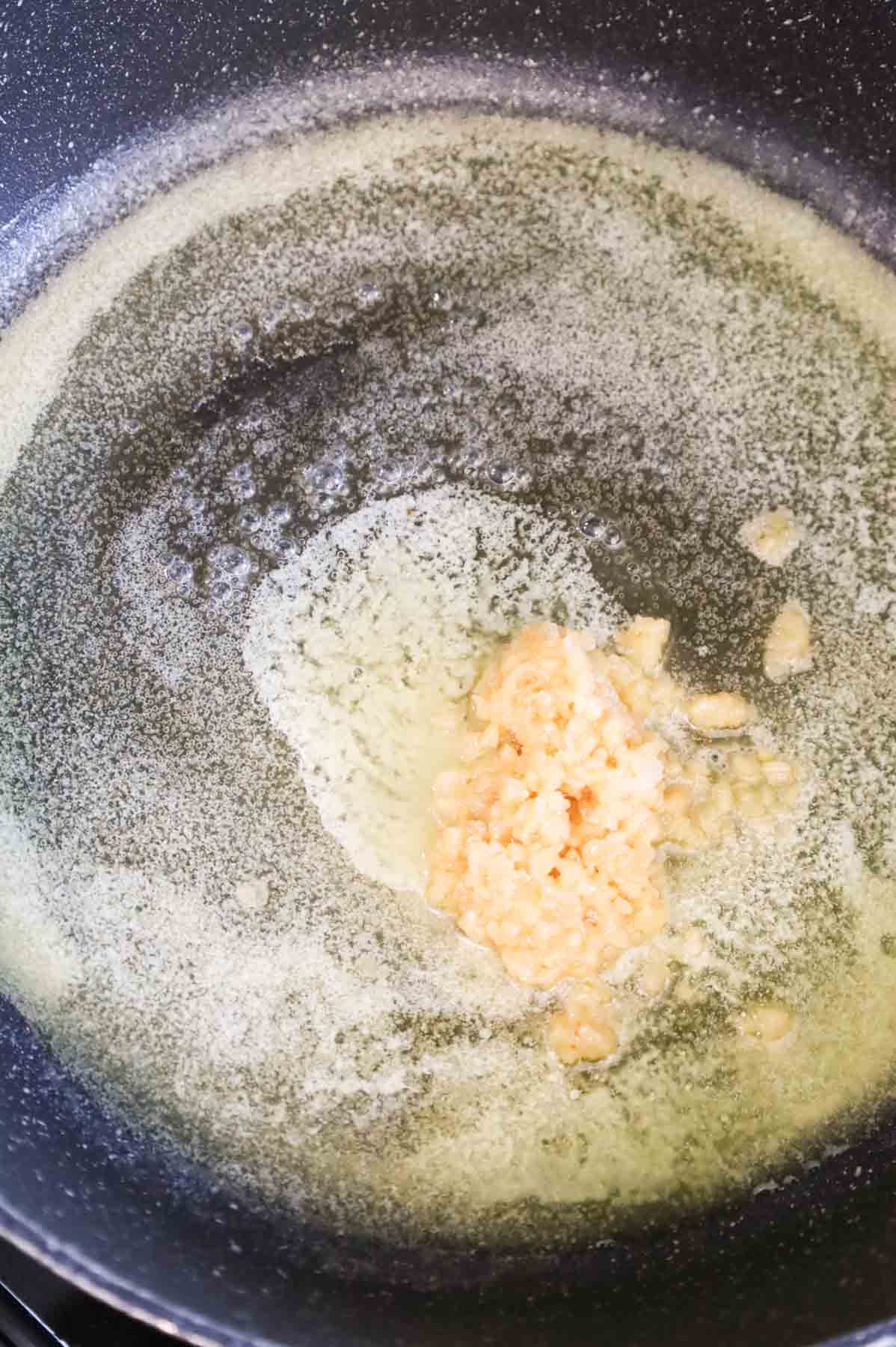 minced garlic and melted butter in a skillet