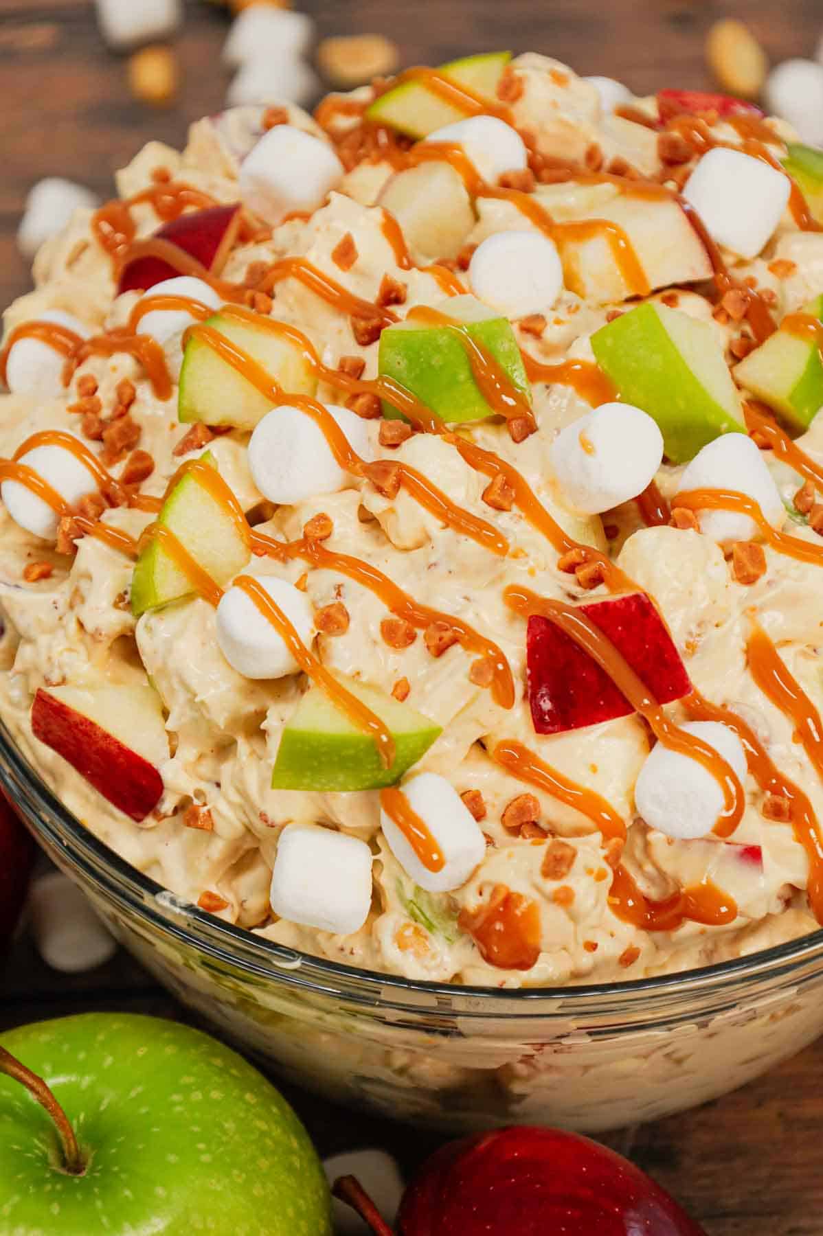 Taffy Apple Salad is a delicious no bake dessert recipe loaded with diced apples, peanuts, Skor bits and mini marshmallows all tossed in a Cool Whip and vanilla pudding mixture.