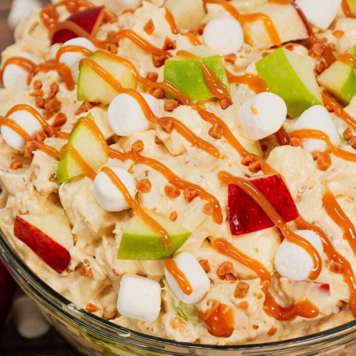 Taffy Apple Salad is a delicious no bake dessert recipe loaded with diced apples, peanuts, Skor bits and mini marshmallows all tossed in a Cool Whip and vanilla pudding mixture.