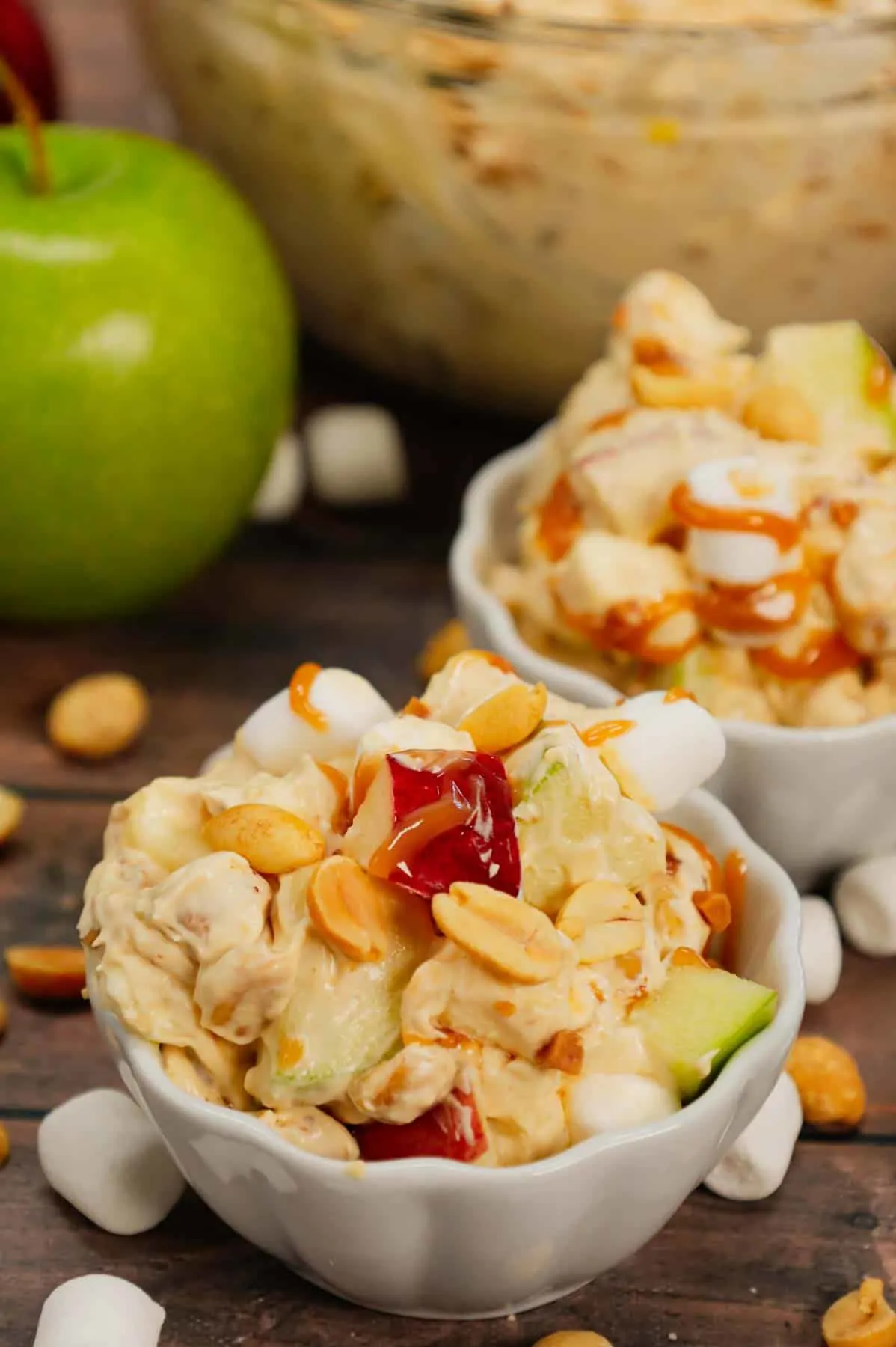 Taffy Apple Salad is a delicious no bake dessert recipe loaded with diced apples, peanuts, Skor bits and mini marshmallows all tossed in a Cool Whip and vanilla pudding mixture.