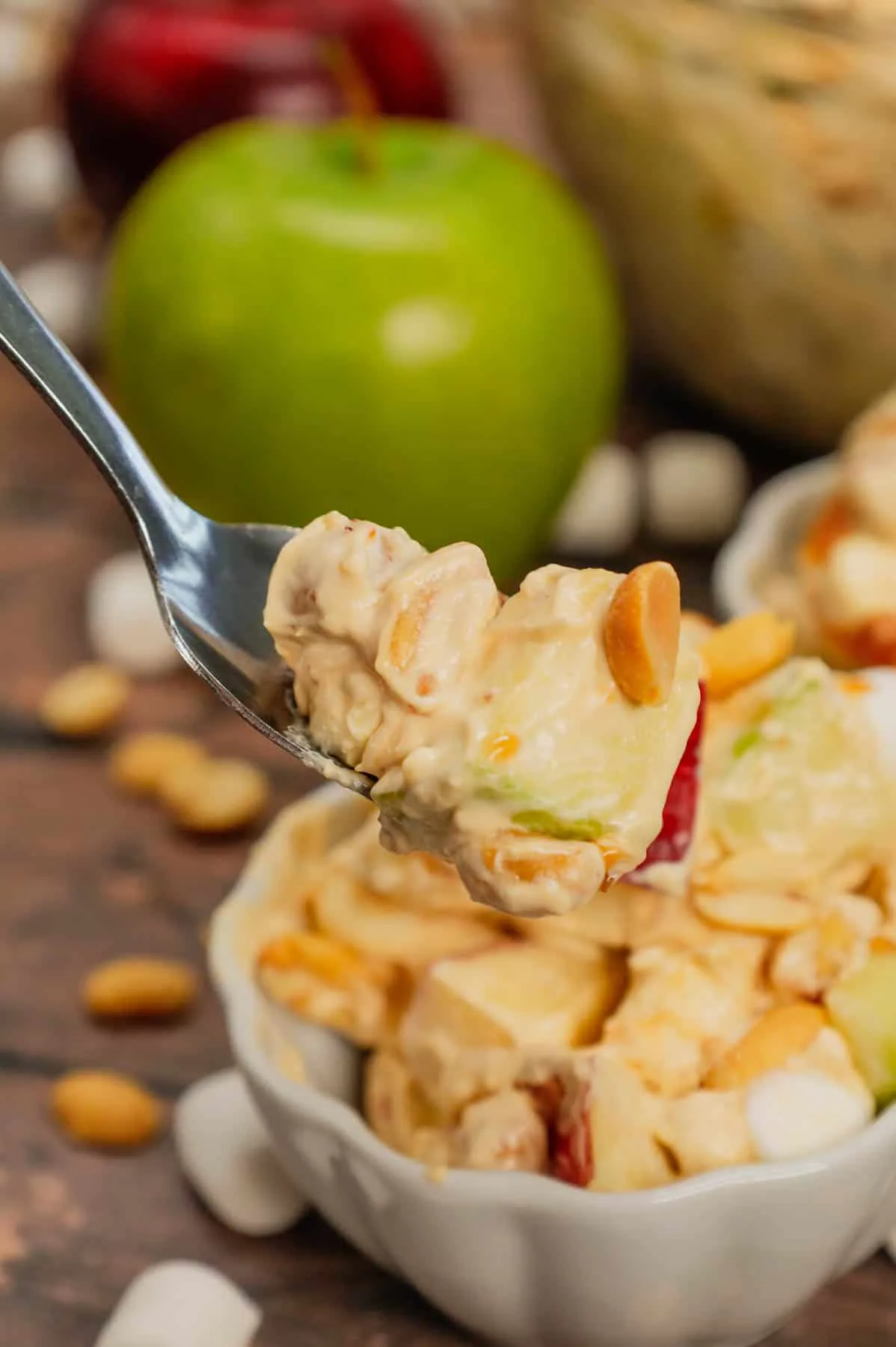Taffy Apple Salad is a delicious no bake dessert recipe loaded with diced apples, peanuts, Skor bits and mini marshmallows all tossed in a Cool Whip and vanilla pudding mixture.