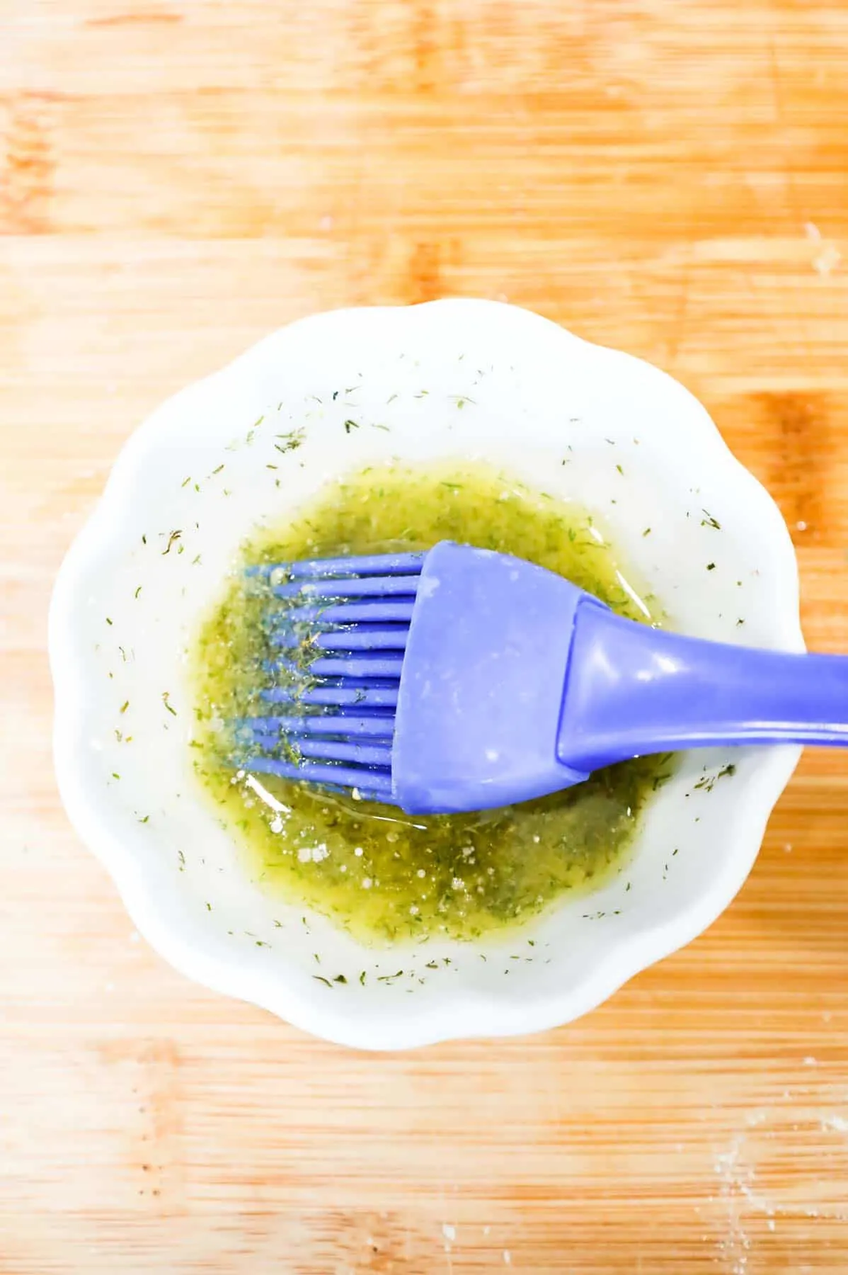 stirring melted butter and seasonings together in a bowl