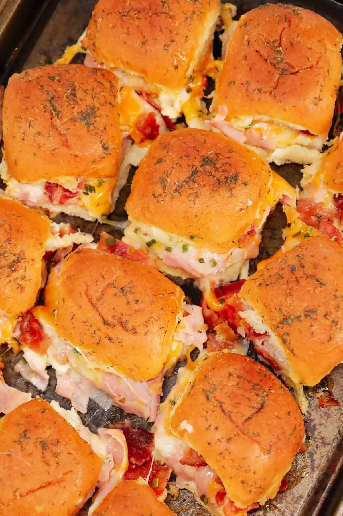 Turkey Bacon Ranch Sliders are small baked sandwiches loaded with chopped deli turkey, ranch dressing, crispy bacon and cheddar cheese.