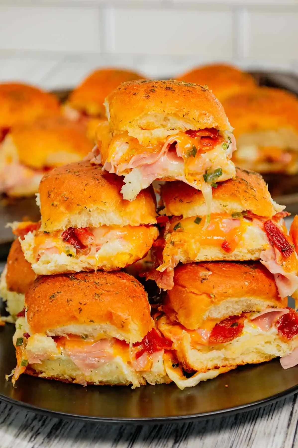 Turkey Bacon Ranch Sliders are small baked sandwiches loaded with chopped deli turkey, ranch dressing, crispy bacon and cheddar cheese.