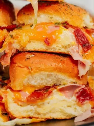 Turkey Bacon Ranch Sliders are small baked sandwiches loaded with chopped deli turkey, ranch dressing, crispy bacon and cheddar cheese.