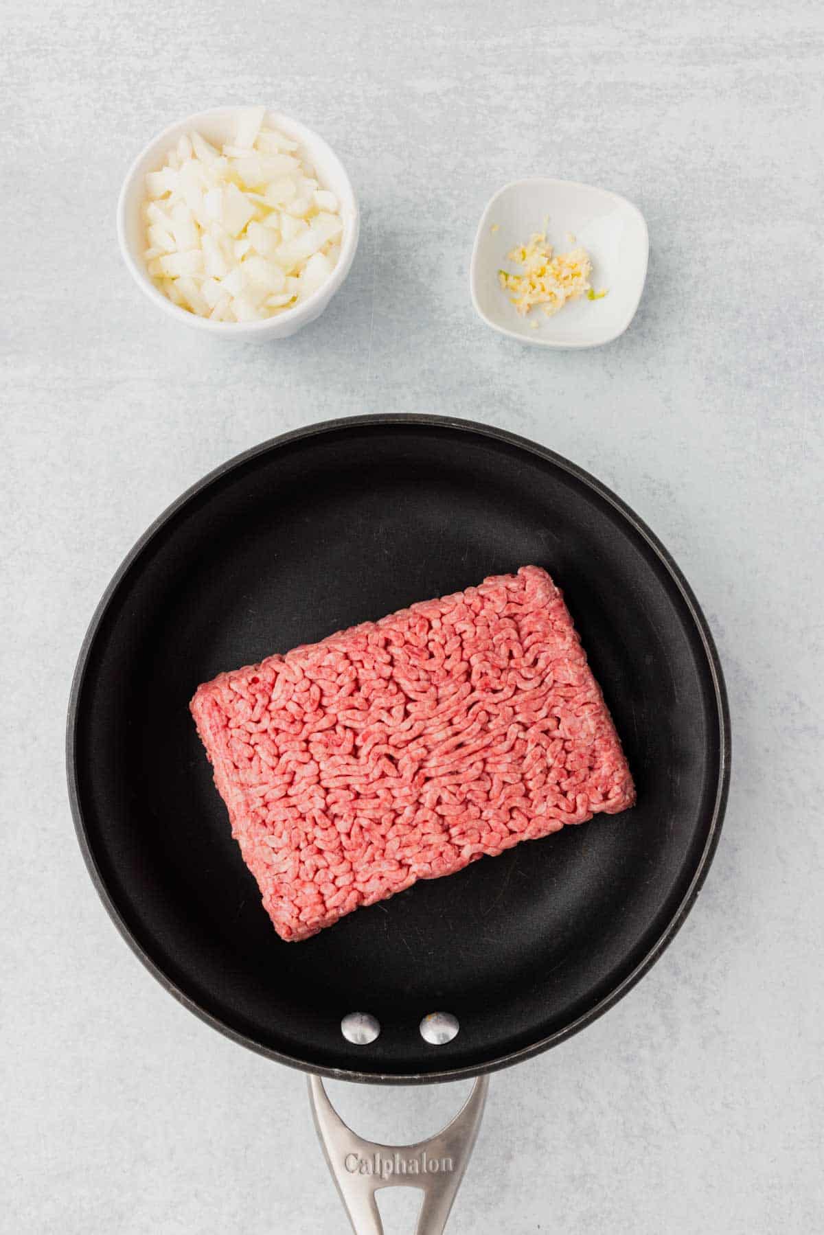 raw ground beef in a skillet