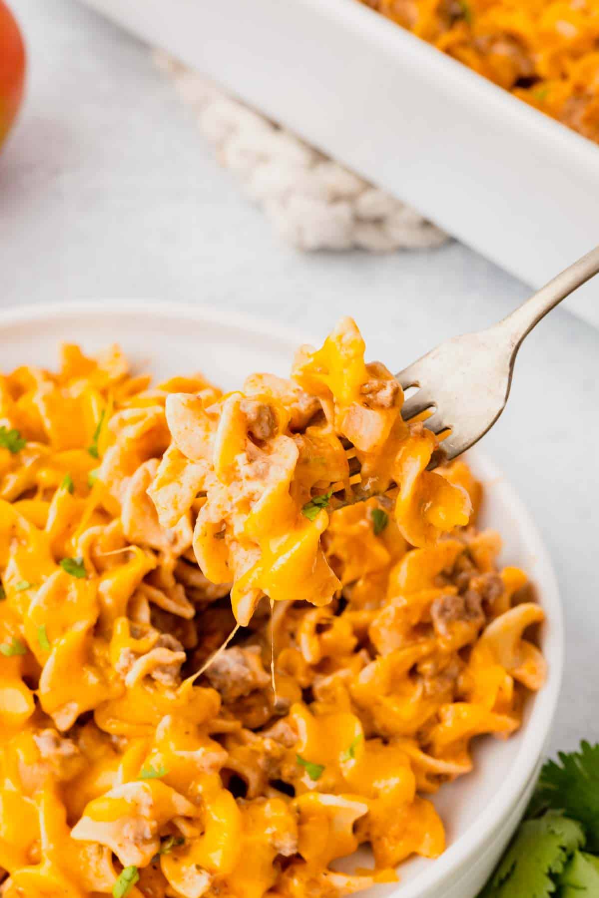 Beef Noodle Casserole is a hearty dish loaded with ground beef, egg noodles, cheddar cheese, sour cream and cream of mushroom soup.