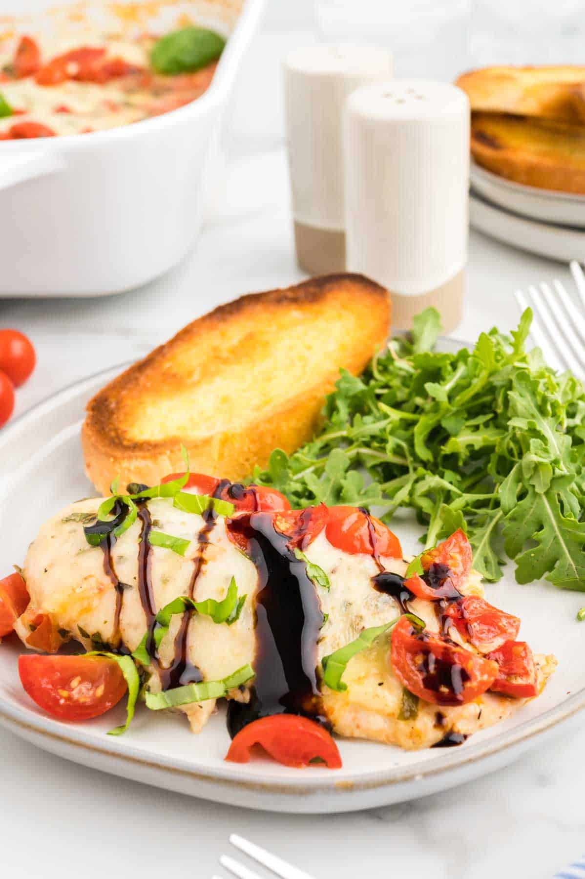 Bruschetta Chicken Bake is a simple baked chicken breast recipe loaded with cherry tomatoes, fresh basil, garlic and melty mozzarella cheese.