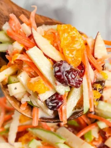 Carrot Apple Salad is a delicious and colourful salad loaded with sliced red and green apples, carrots, dried cranberries and mandarins all tossed in a vanilla yogurt and mayo dressing.