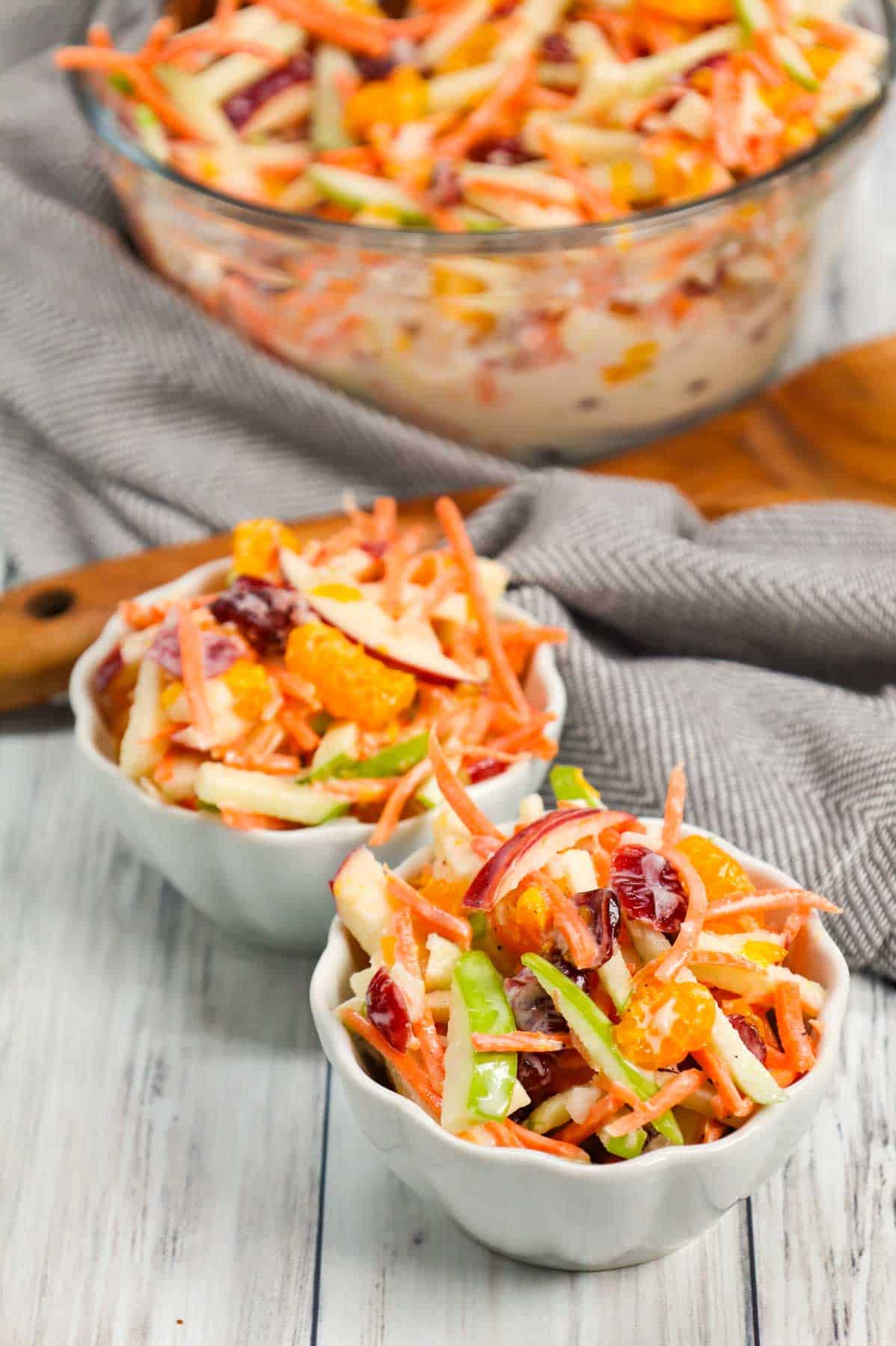 Carrot Apple Salad is a delicious and colourful salad loaded with sliced red and green apples, carrots, dried cranberries and mandarins all tossed in a vanilla yogurt and mayo dressing.