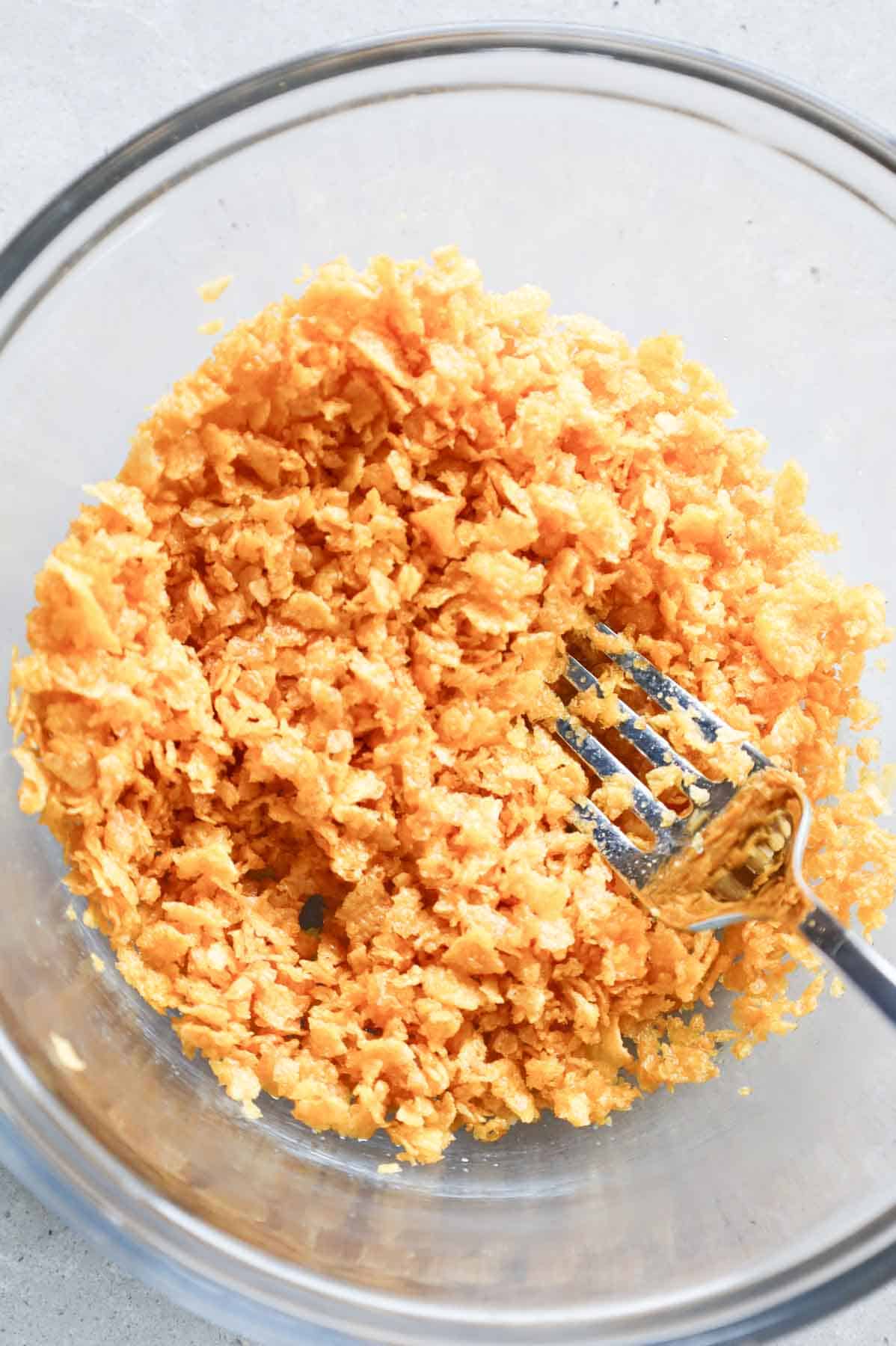 crushed cornflake and butter mixture in a bowl