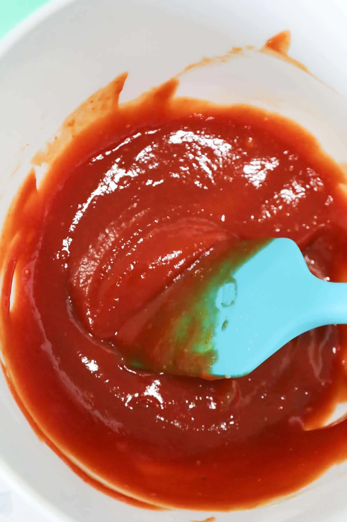 ketchup glaze mixture being stirred in a bowl