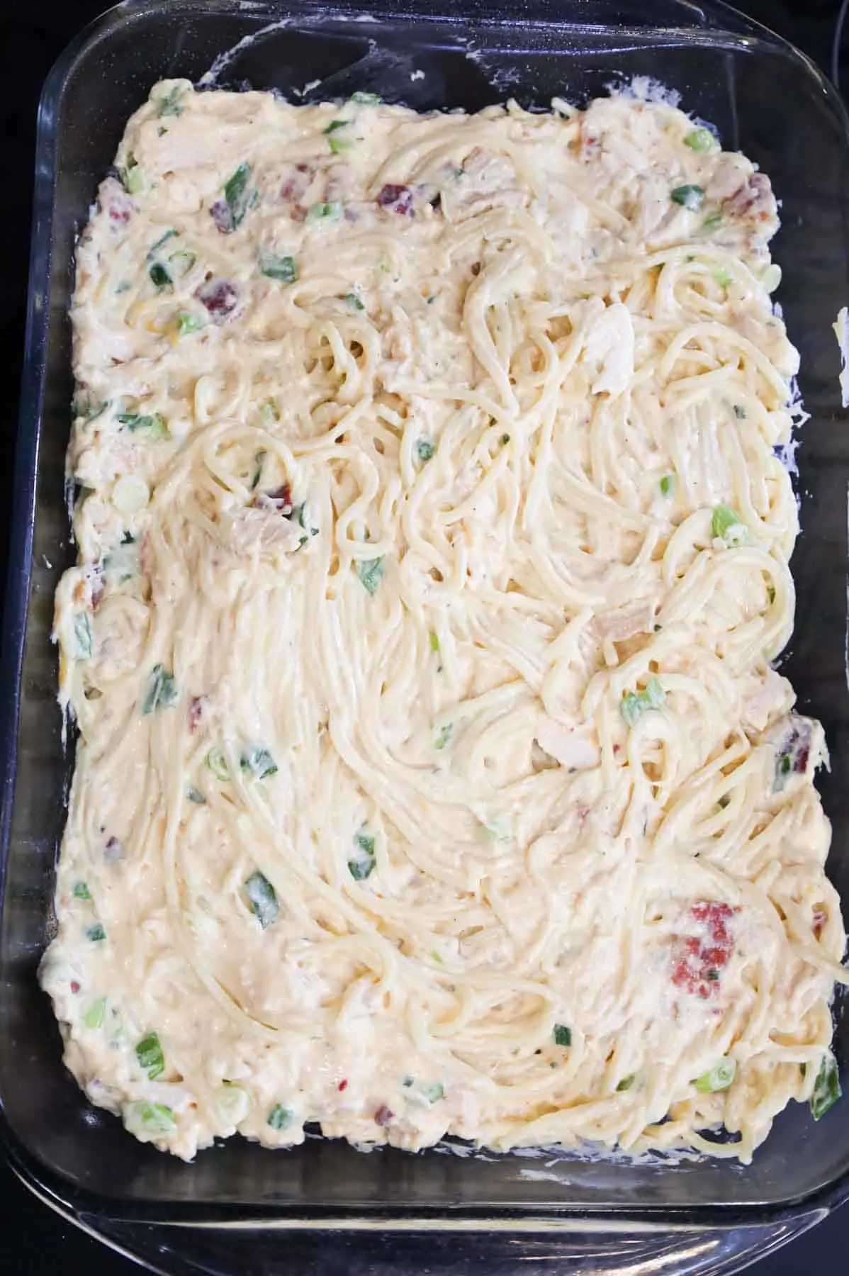 creamy chicken spaghetti in a baking dish