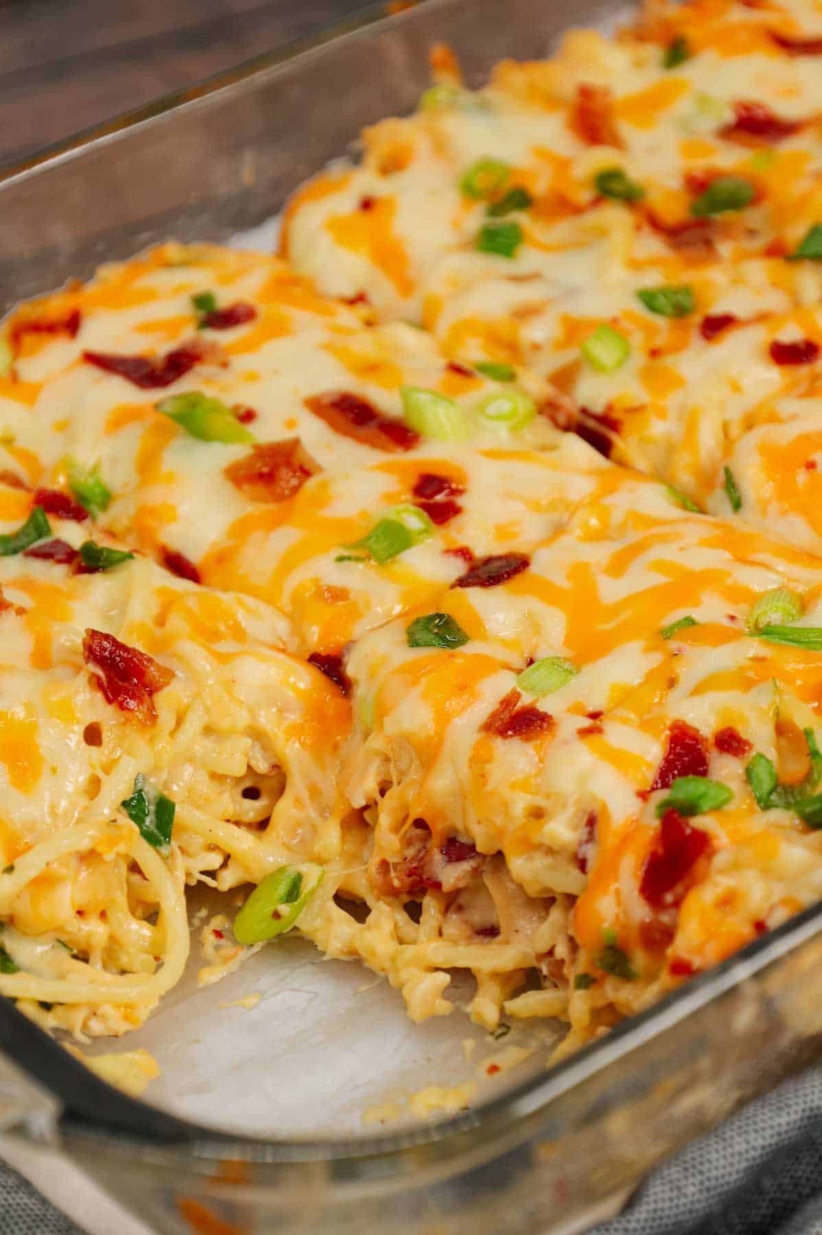 Crack Chicken Spaghetti is a delicious baked pasta recipe with a creamy sauce and loaded with shredded chicken, crumbled bacon, chopped green onions, ranch dressing mix and shredded cheddar and mozzarella cheese.