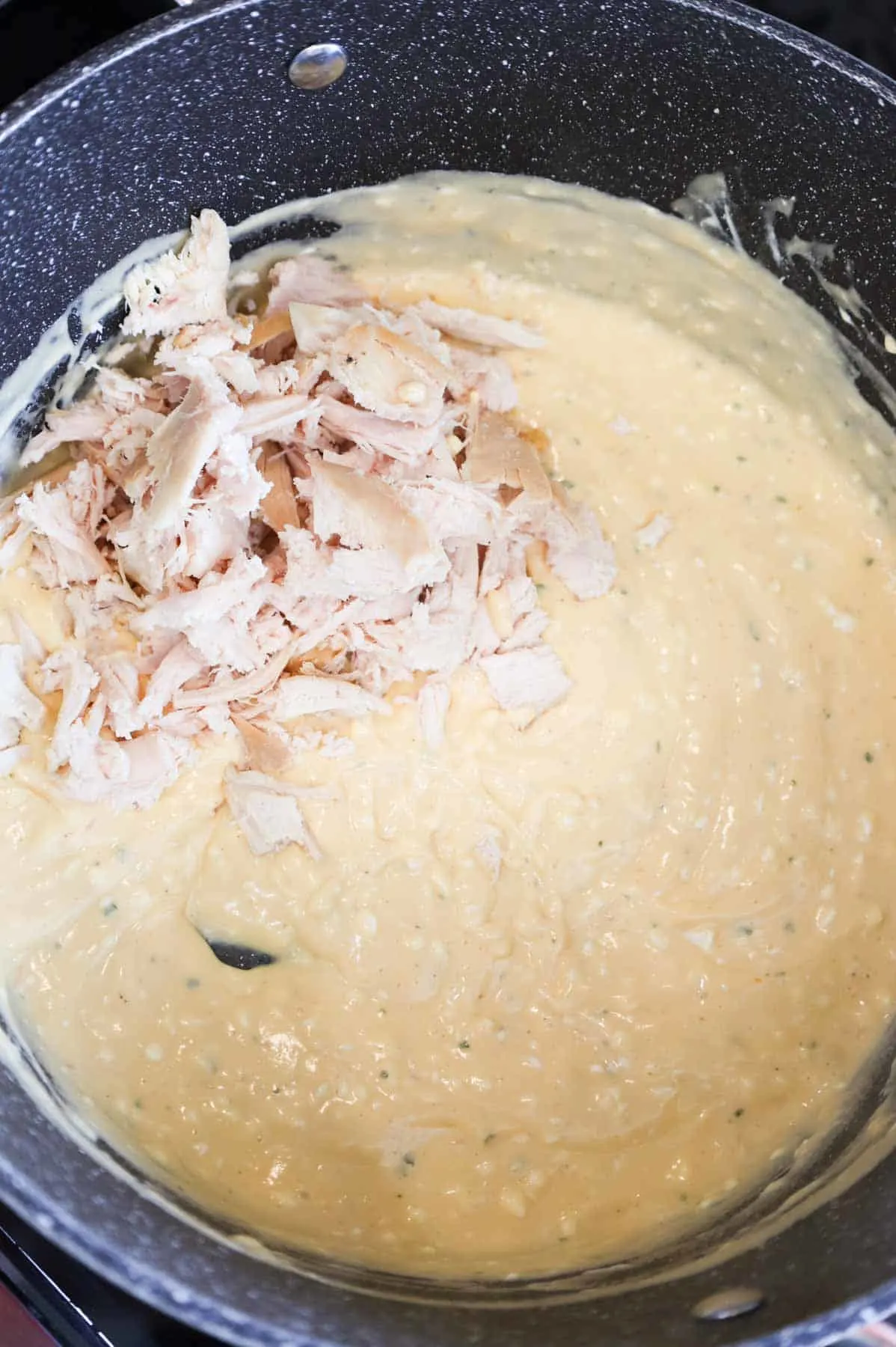 shredded chicken added to pot with cream cheese and cream soup mixture