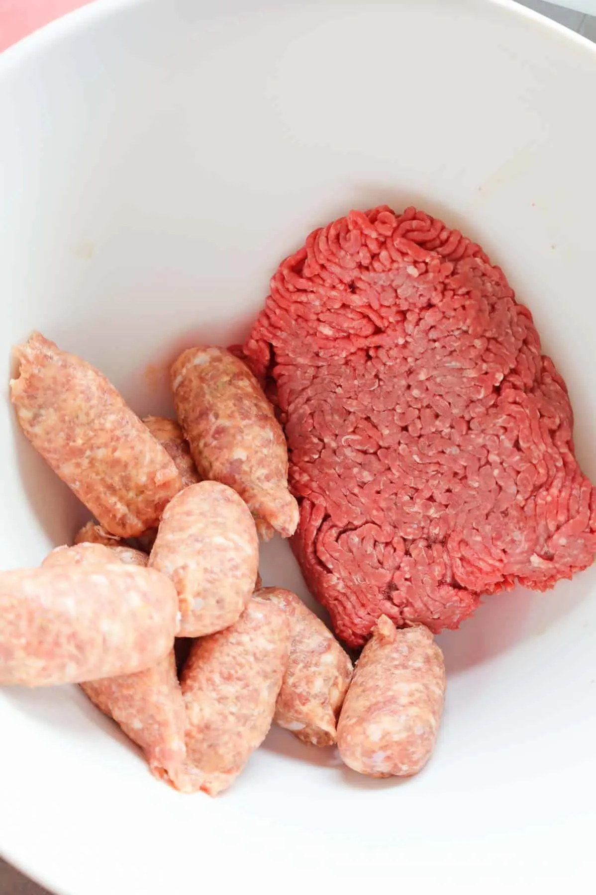 ground beef and Italian sausage meat in a mixing bowl