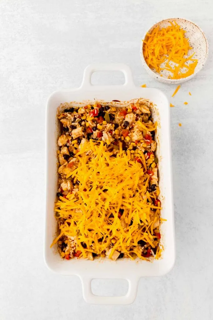 shredded cheese on top of chicken and rice casserole