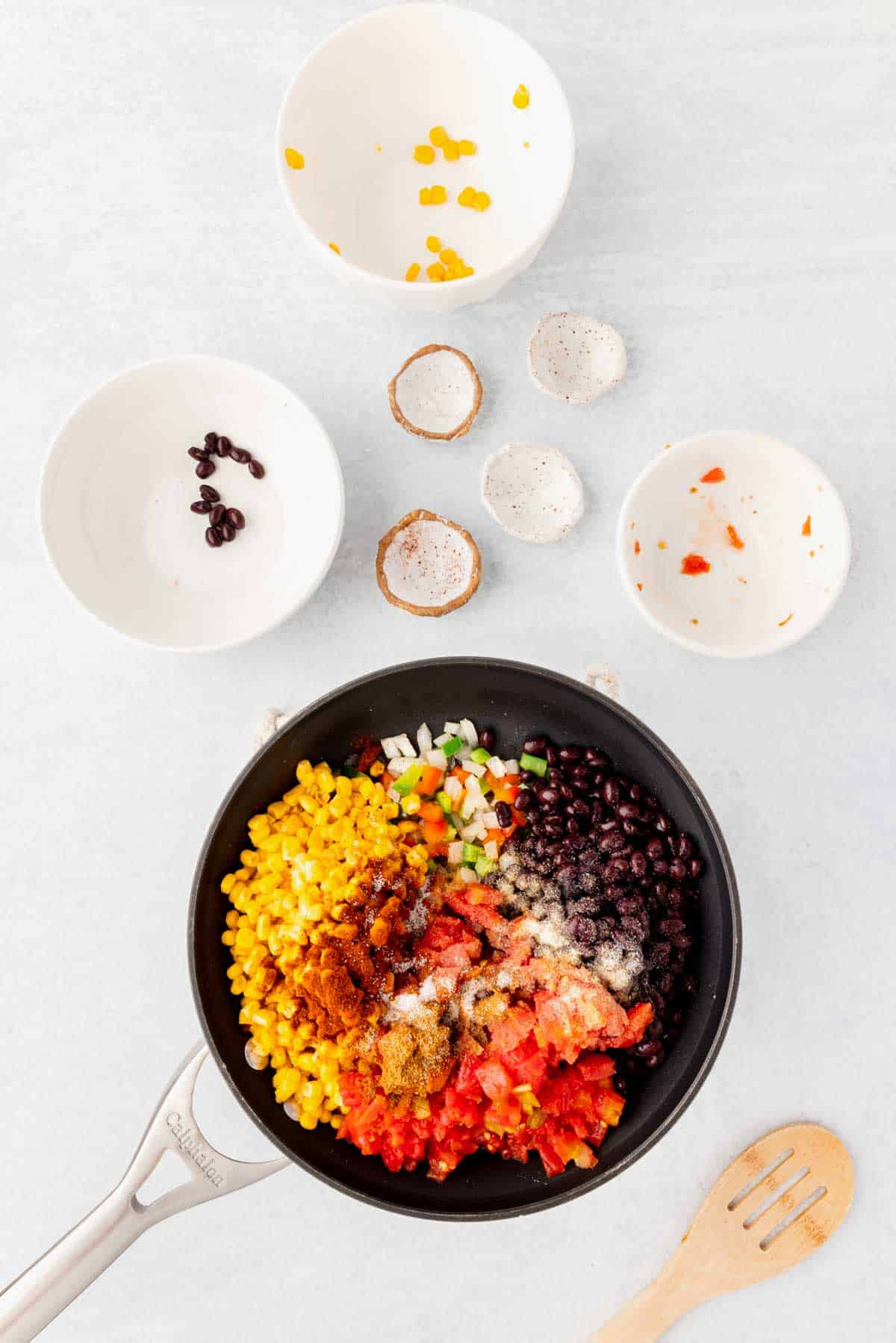 diced onions and bell peppers, corn, Rotel, black beans and spices in a skillet