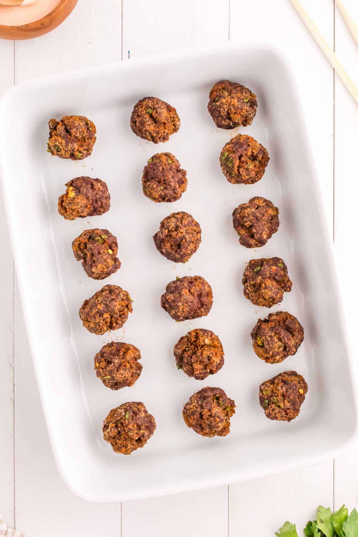 cooked meatballs in a baking dish