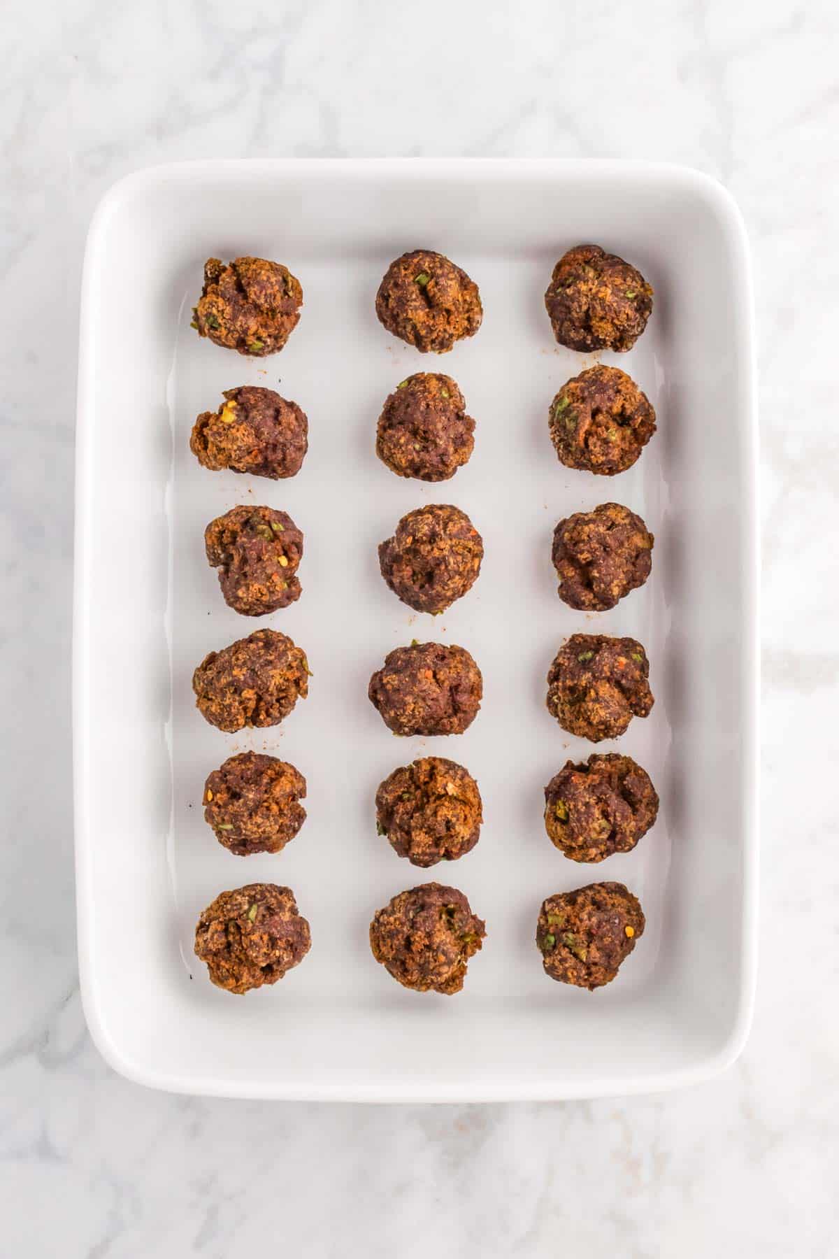 cooked meatballs in a baking dish