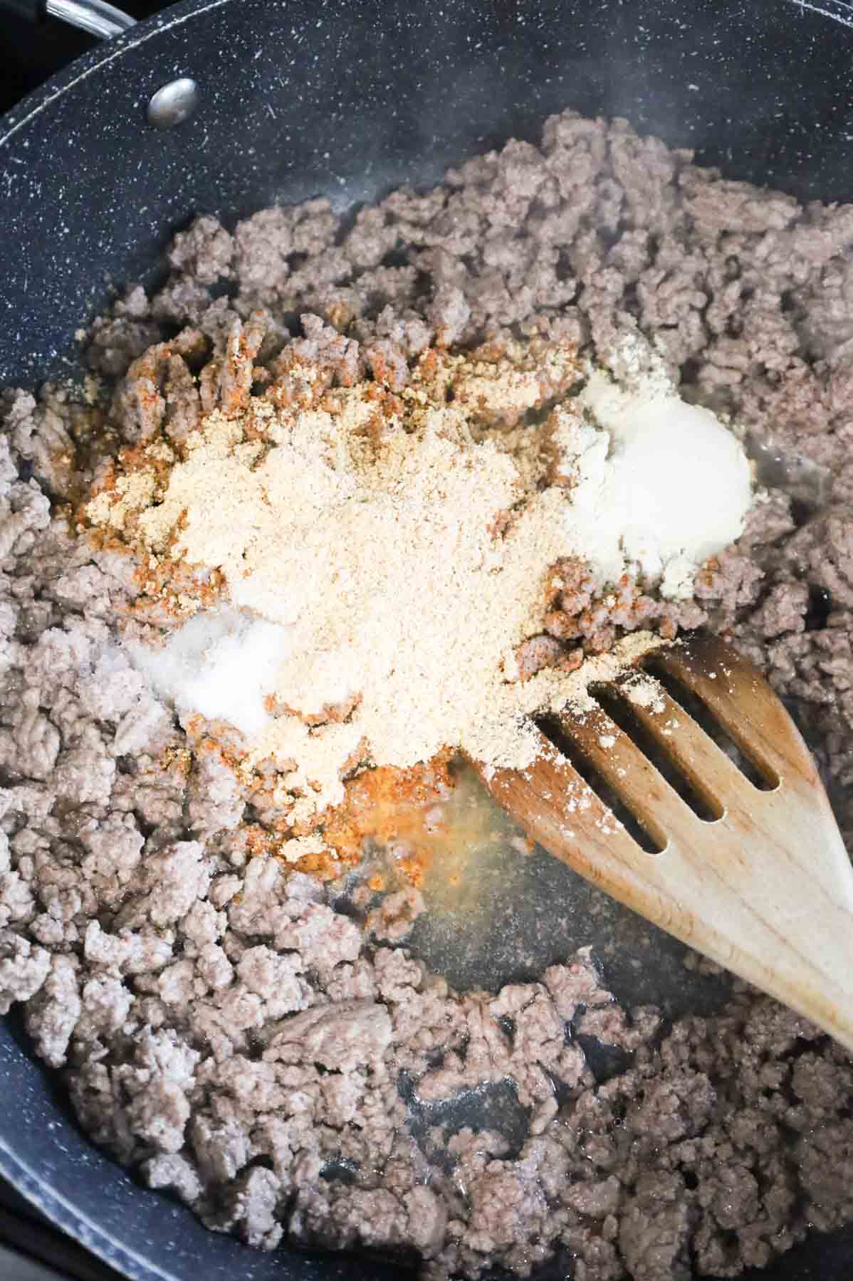taco seasoning, onion power, salt and water added to skillet with cooked ground beef