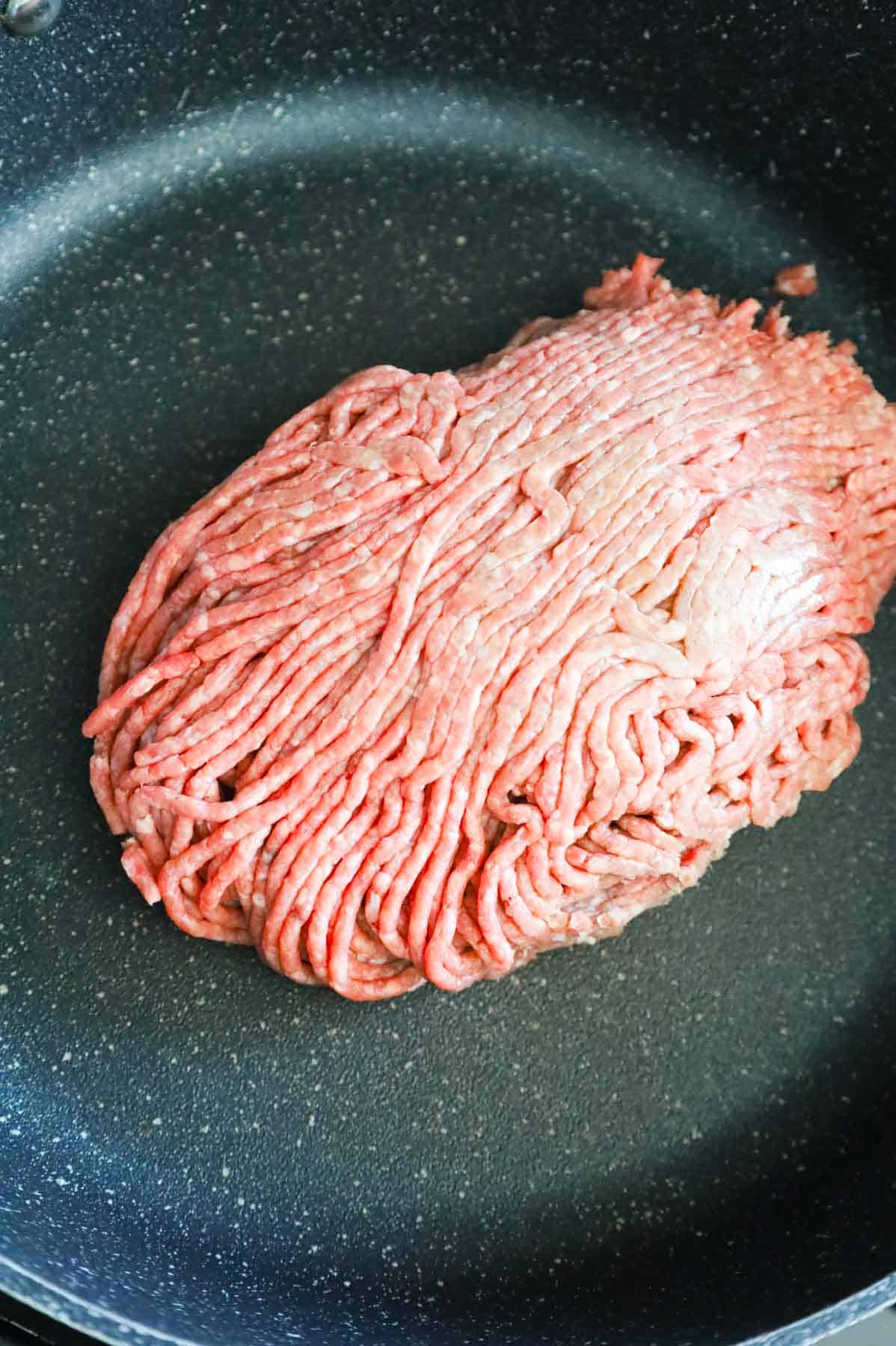 raw ground beef in a skillet