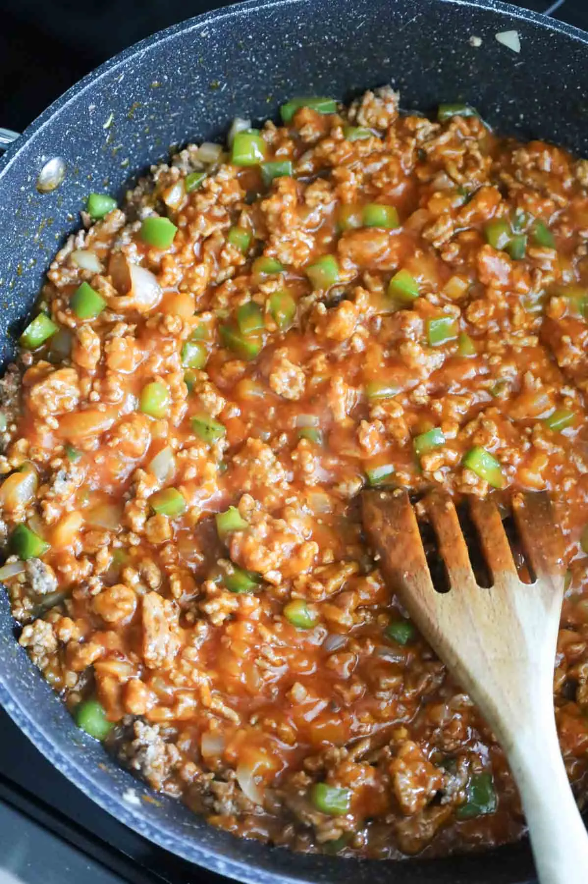 tomato soup, ground beef, diced onions and peppers mixture in a skillet