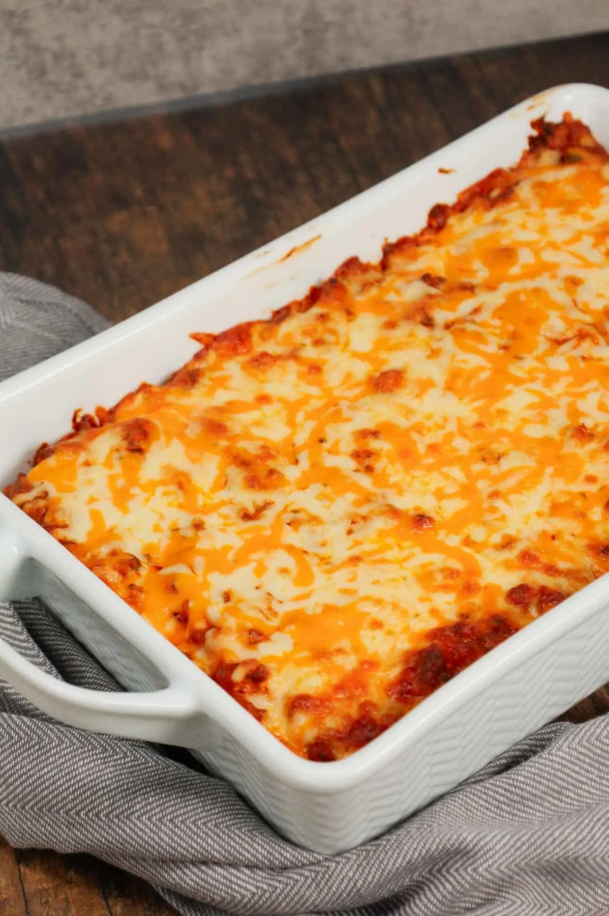 Grandma's Ground Beef Casserole is a simple and classic hamburger dish made with egg noodles, condensed tomato soup, onions, green bell peppers and cream cheese all baked with shredded mozzarella and cheddar on top.