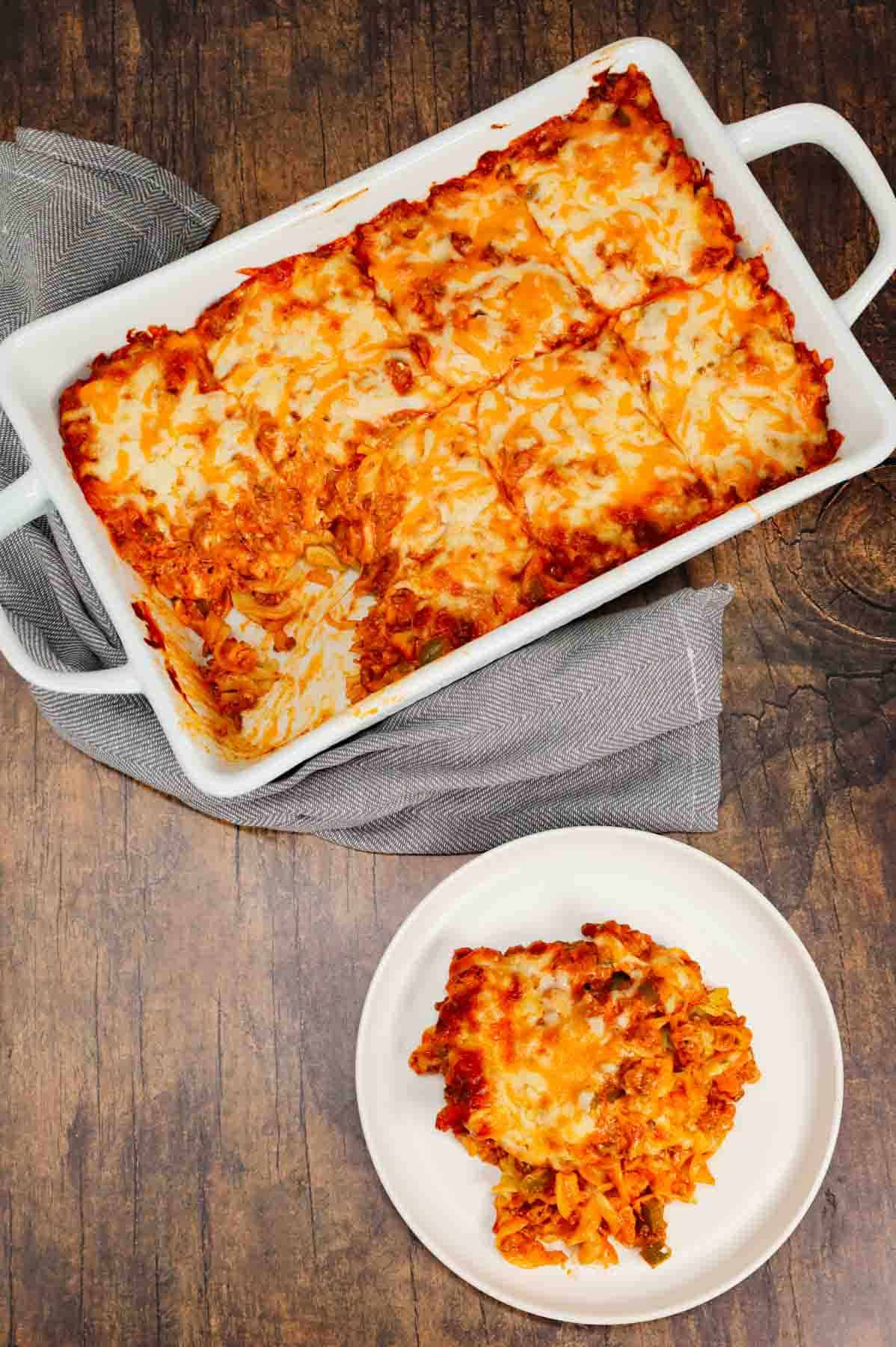 Grandma's Ground Beef Casserole is a simple and classic hamburger dish made with egg noodles, condensed tomato soup, onions, green bell peppers and cream cheese all baked with shredded mozzarella and cheddar on top.