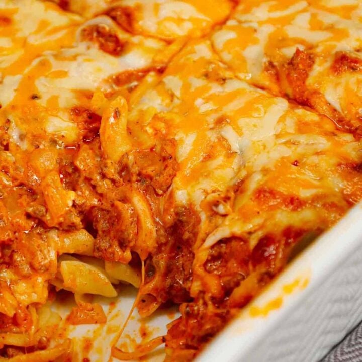 Grandma's Ground Beef Casserole is a simple and classic hamburger dish made with egg noodles, condensed tomato soup, onions, green bell peppers and cream cheese all baked with shredded mozzarella and cheddar on top.