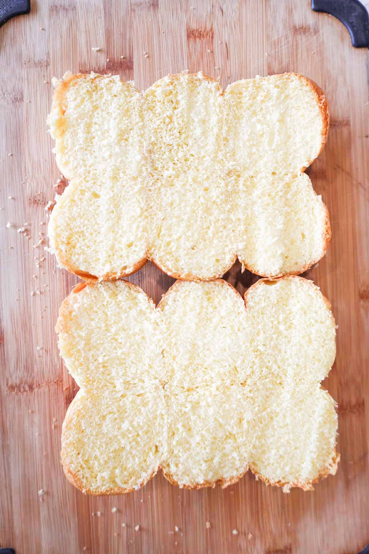 dinner roll halves on cutting board