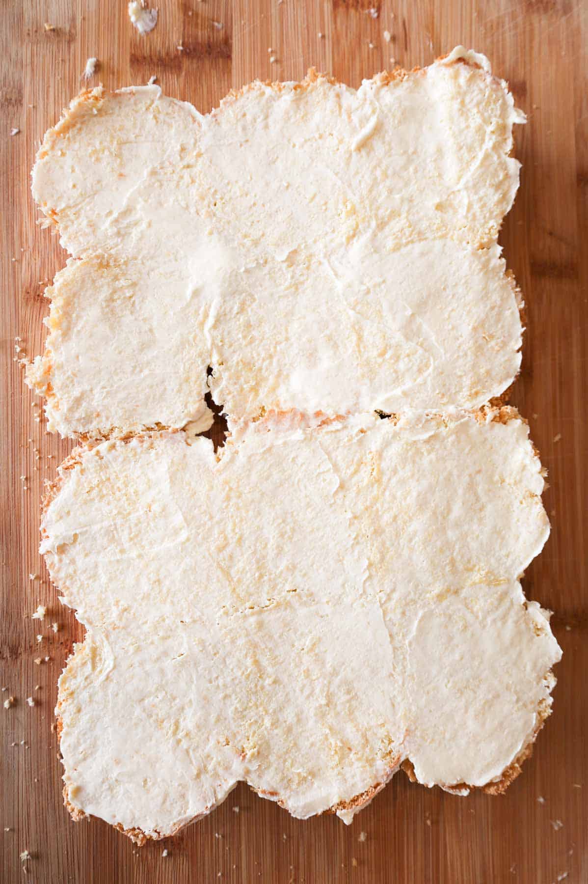 margarine spread on cut dinner rolls on a cutting board
